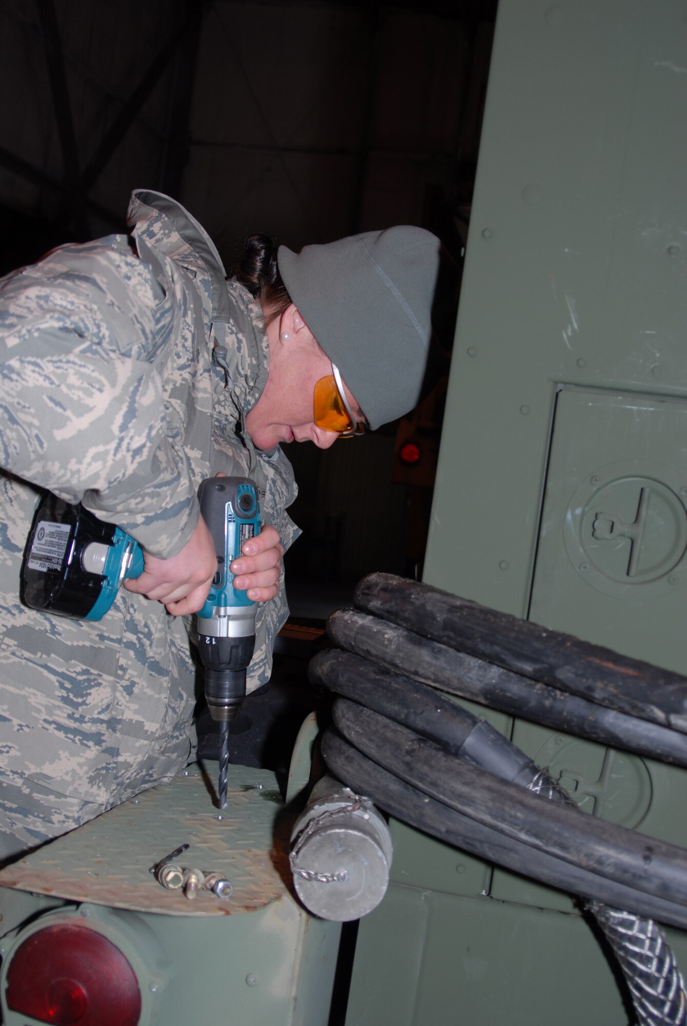 Airman First Class Devon Carroll of the 260th Air Traffic Control Squadron begins installation of external fuel tank mounts on a MEP805 Generator.  The generator is being prepared for deployment to Haiti along with the units mobile control tower and about 12 personnel in support of relief efforts after the recent earthquake.