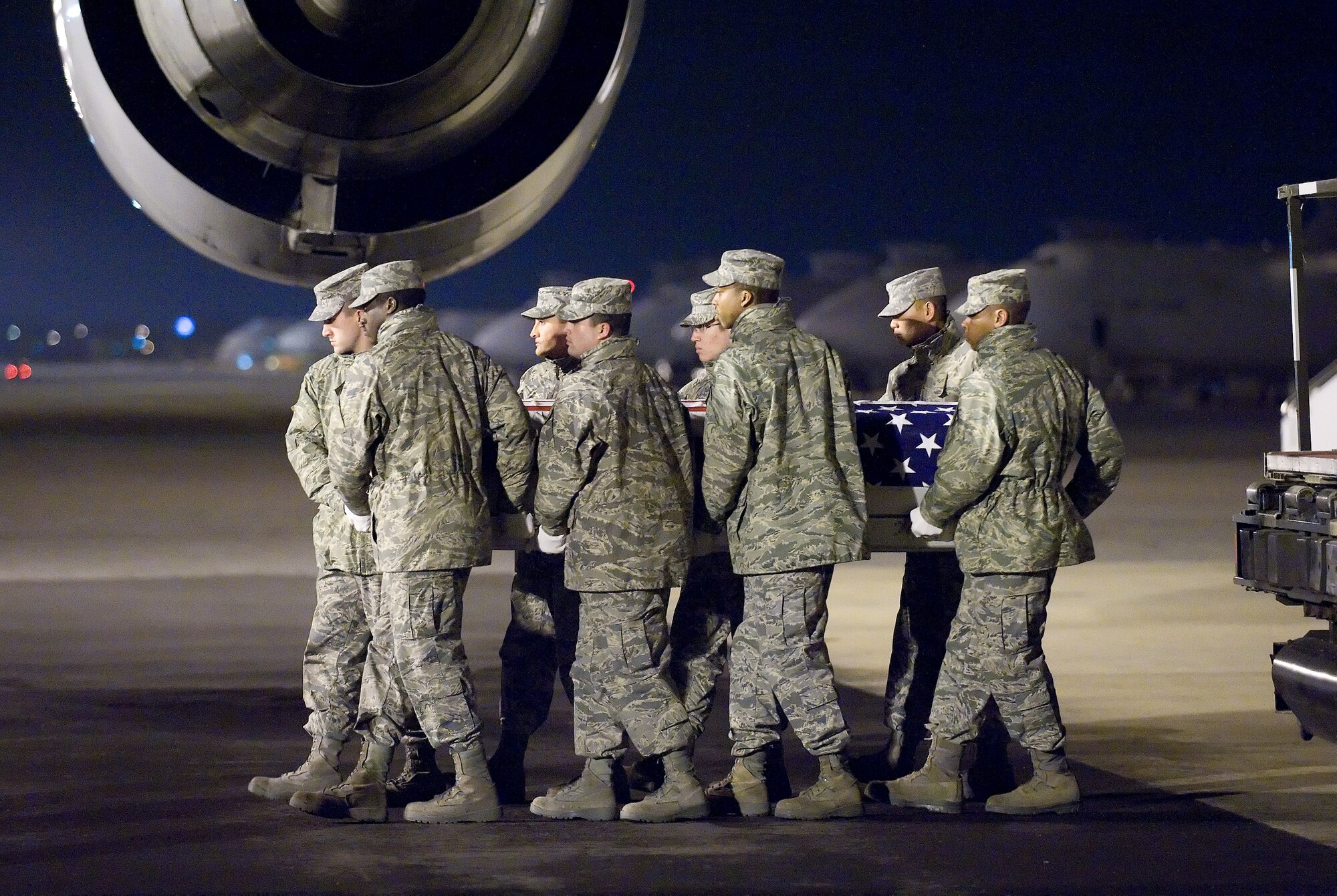 20 January 2010  USAF Photo by Jason Minto.  A U.S. Air Force carry team transfers the remains of Air Force TSgt Adam K. Ginett of Knightdale, NC, at Dover Air Force Base, Del., Jan 20, 2010.  