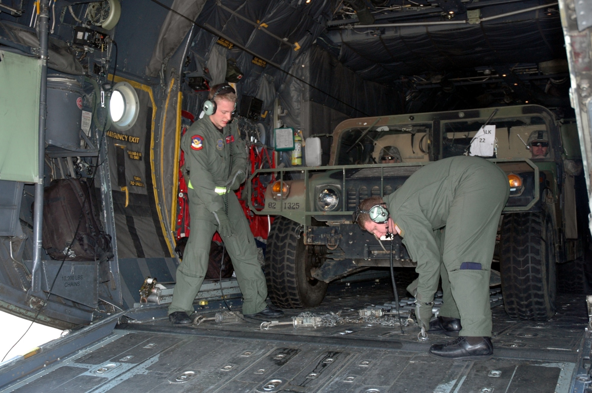 PORT-AU-PRINCE, Haiti -- Two 317th Airlift Group Airmen unhook a Highly Mobility Multipurpose Wheeled Vehicle from a C-130 Hercules while stopped at the Port-au-Prince Toussaint Louverture International Airport in Haiti Jan. 19. The C-130 crew of six departed Dyess Air Force Base to support relief efforts following the 7.0-magnitude earthquake that devistated the Caribbean nation Jan. 14. The Air Force's airlift capability enables the United States to respond immediately to any disaster domestically or worldwide. We are the only country with an aircraft fleet capable of providing this type of response. (U.S. Air Force photo/ Airman 1st Class Robert Hicks) 