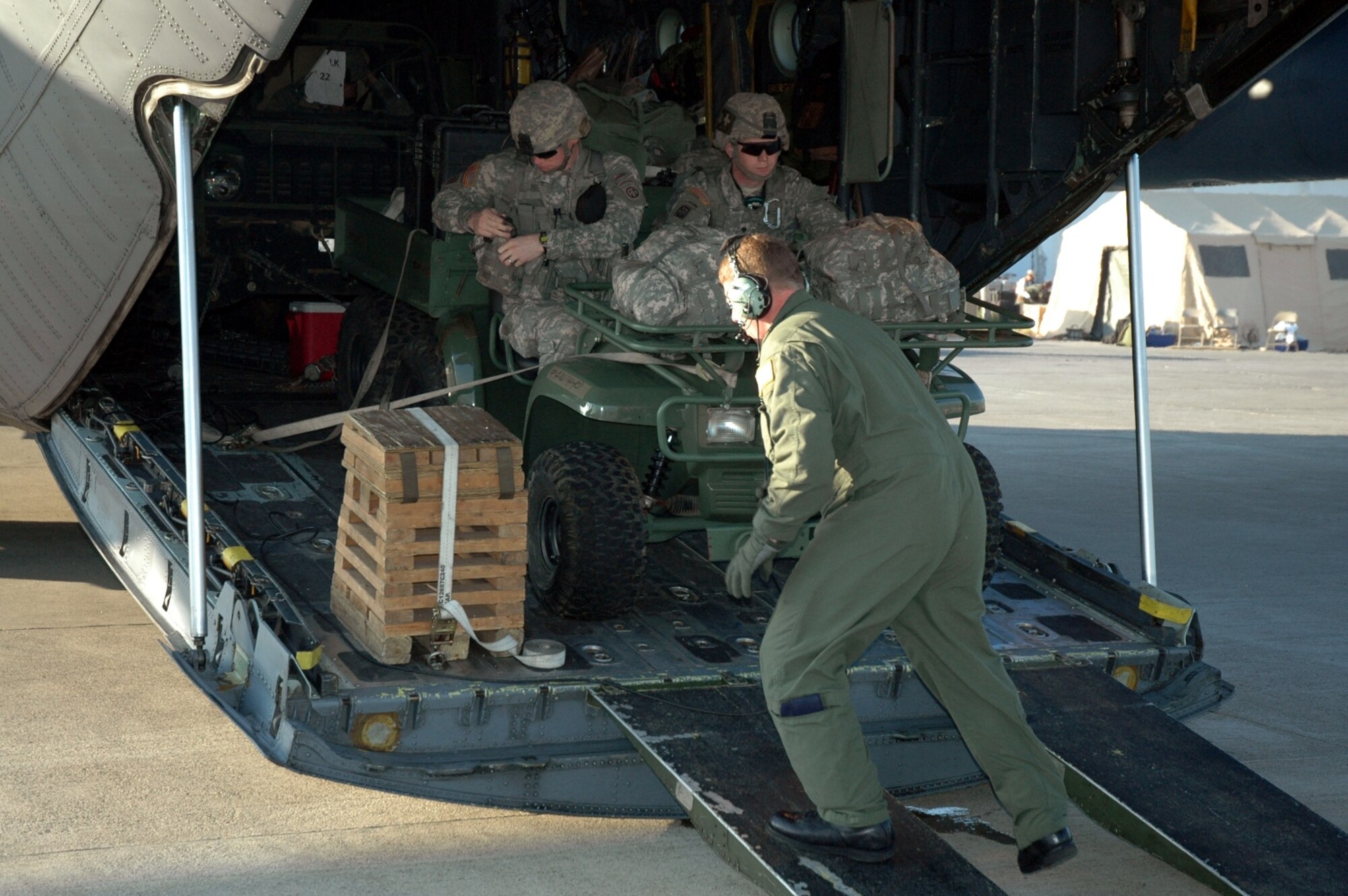 PORT-AU-PRINCE, Haiti -- A 317th Airlift Group Airman hurries to free a “Gator”, six wheel vehicle, from a C-130 Hercules while stopped at the Port-au-Prince Toussaint Louverture International Airport in Haiti Jan. 19. The C-130 crew of six departed Dyess Air Force Base to support relief efforts following the 7.0-magnitude earthquake that devistated the Caribbean nation Jan. 14. The Air Force's airlift capability enables the United States to respond immediately to any disaster domestically or worldwide. We are the only country with an aircraft fleet capable of providing this type of response. (U.S. Air Force photo/ Airman 1st Class Robert Hicks) (U.S. Air Force photo/ Airman 1st Class Robert Hicks) (U.S. Air Force photo/ Airman 1st Class Robert Hicks) 
