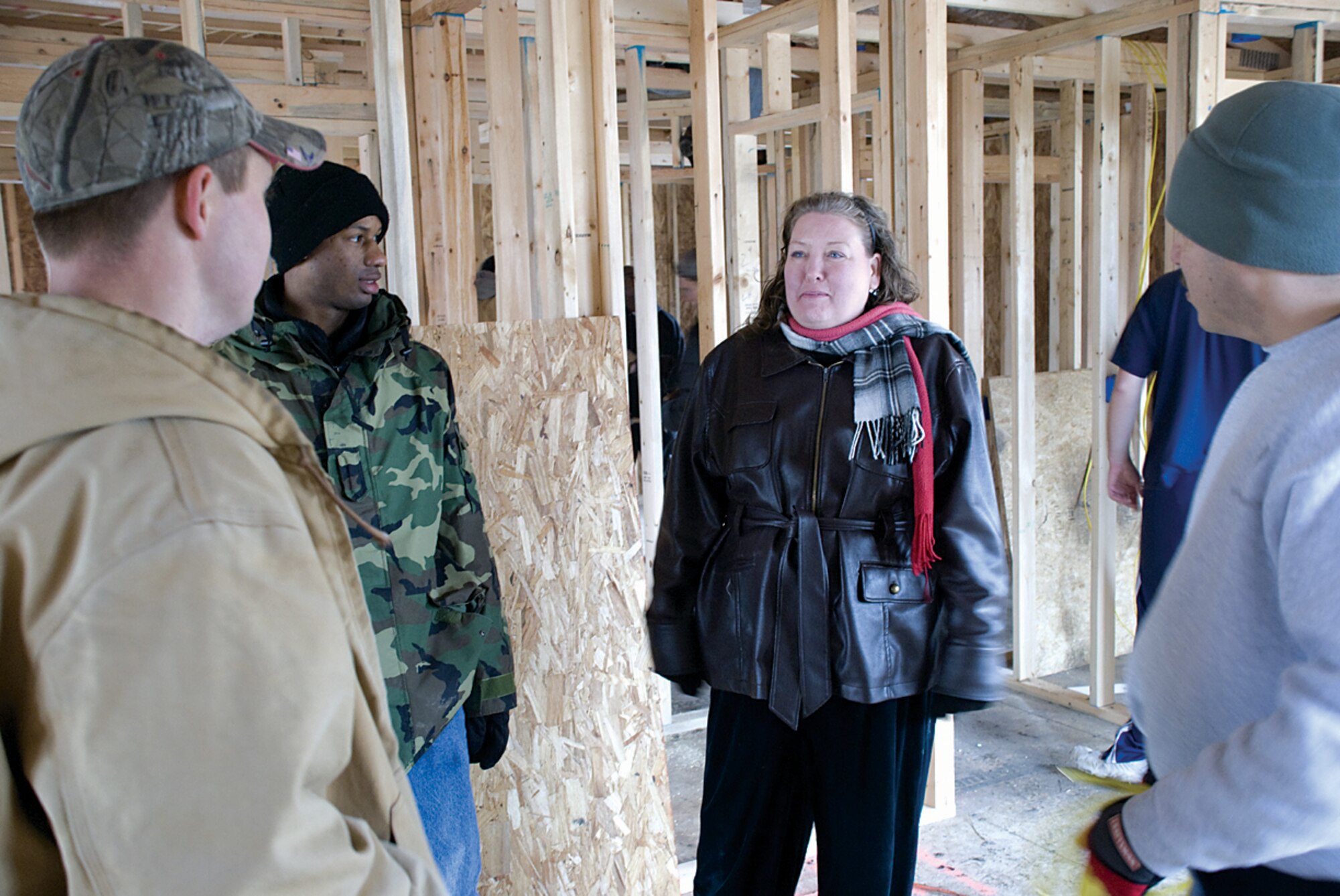 COLLINSVILLE, Ill. -- Staff Sgt. Franklin Rudd, 375th Communications Squadron, runs electrical wiring Saturday at the Habitat for Humanity house.  Volunteers worked with wiring, roofing and other tasks.  The 1,000-square-foot house in State Park Place will feature three bedrooms, one bathroom, kitchen and living room. (U.S. Air Force photo/ Steve Berry)