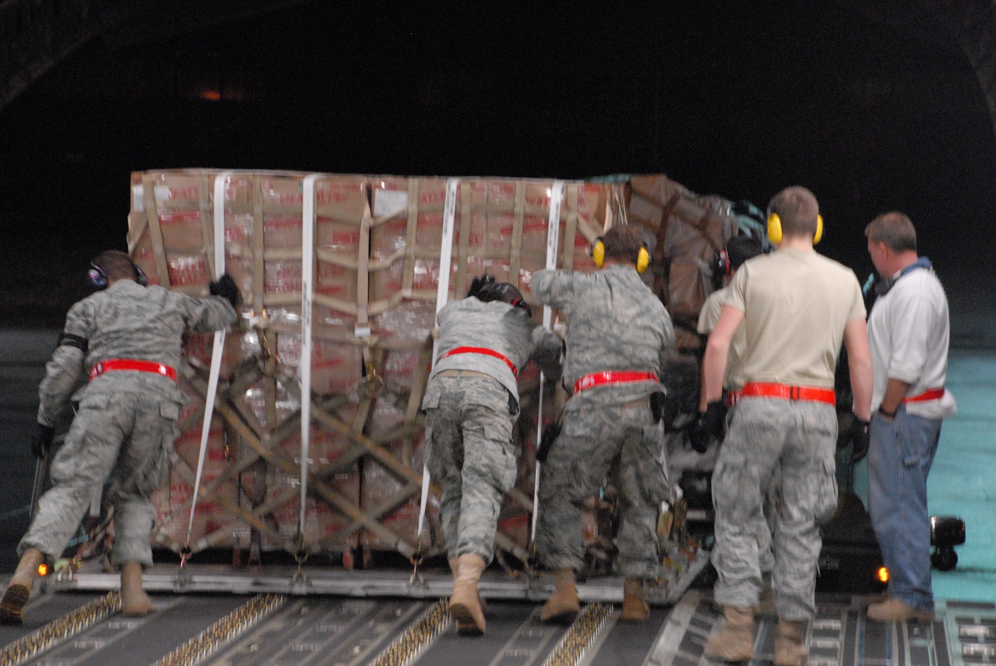 Members of the 3rd Aerial Port Squadron, Pope Air Force Base, N.C., load cargo onto a C-17 Globemaster III.  The 90 tons of cargo was then flown to Haiti to aid in relief efforts.  (U.S. Air Force photo/Staff Sgt. Chad Padgett)  