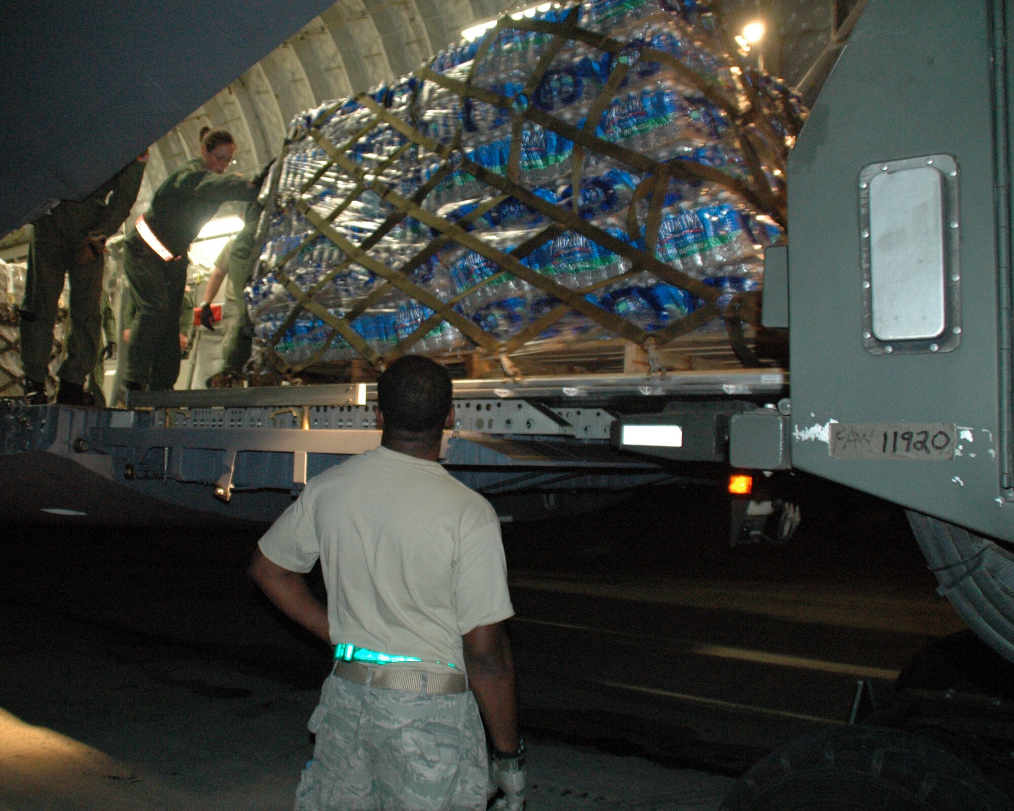 Pallets of water, food and other humanitarian relief supplies are offloaded from a C-17 Globemaster III Jan. 16, 2010, in Port-au-Prince, Haiti.  Supplies are being flown into the earthquake ravaged country around the clock by Air Force aircrews. (U.S. Air Force photo/Tech Sgt. Jeff Kelly)