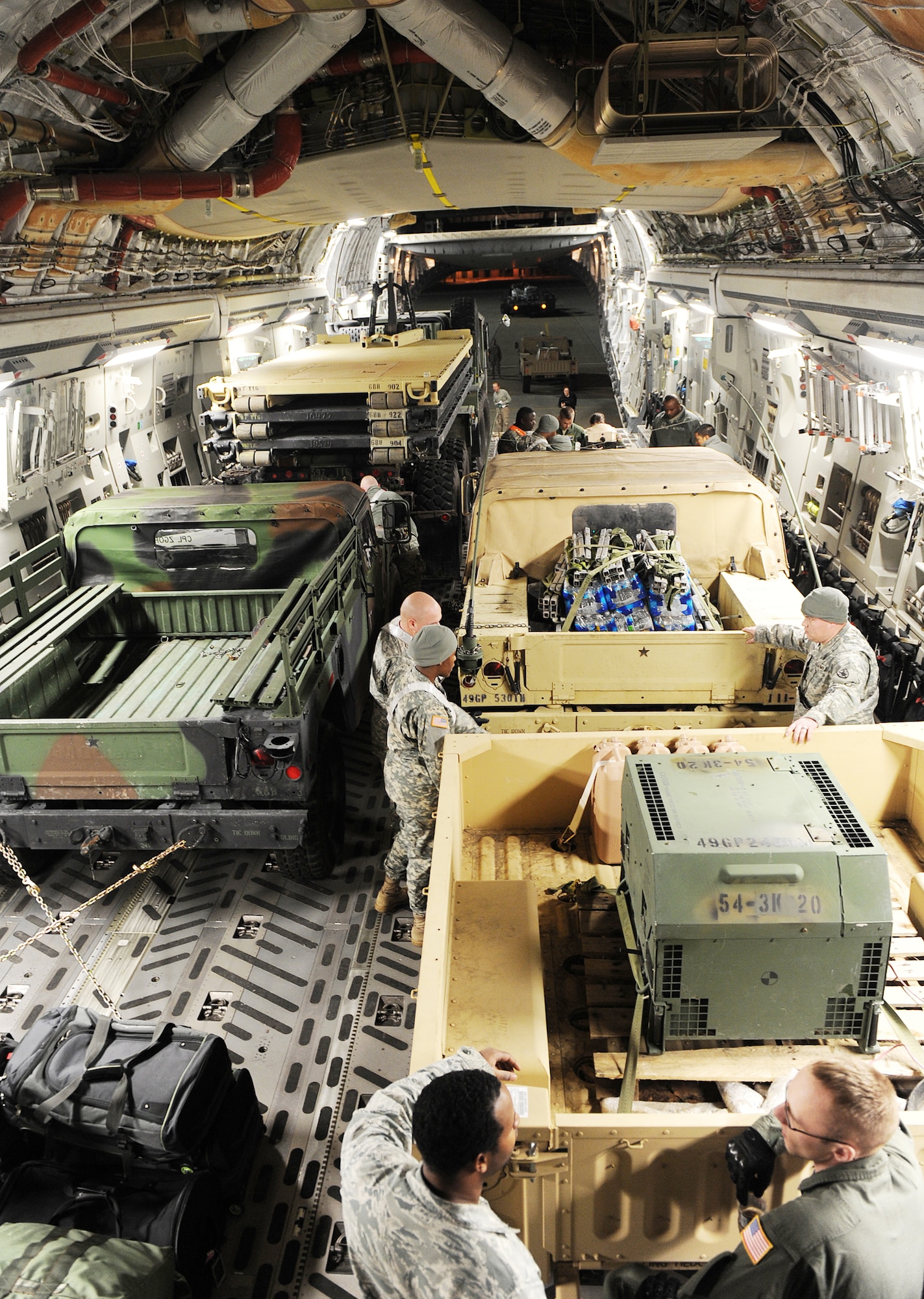 Personnel from Langley Air Force Base, Va., and Fort Eustis, Va., work together to load a C-17 Globemaster III from the 512th Airlift Wing, Dover Air Force Base, Del., Jan. 19, 2010, at Langley AFB. This was part of Operation Unified Response. (U.S. Air Force photo/Senior Airman Zachary Wolf)