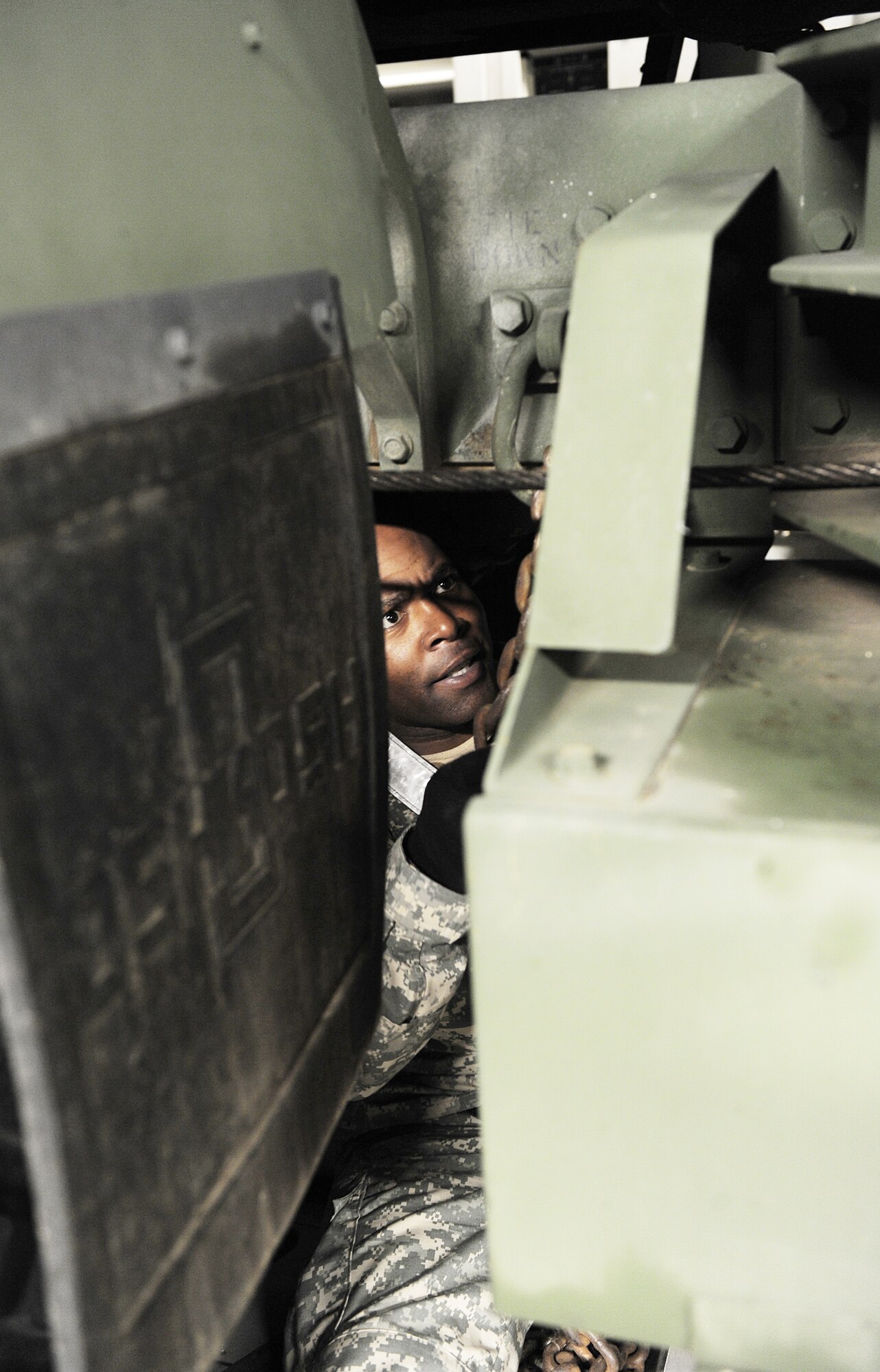 Army Sgt. Ronald Cooper secures an M1120 Heavy Expanded Mobility Tactical Truck Load Handling System in the C-17 Globemaster III from the 512th Airlift Wing, Dover Air Force Base, Del., Jan. 19, 2010, at Langley Air Force Base, Va. Personnel from Langley and Fort Eustis, Va., worked together to load the C-17 as part Operation Unified Response. Sergeant Cooper is a cargo specialist assigned to the Headquarters, Det. 24. (U.S. Air Force photo/Senior Airman Zachary Wolf)  