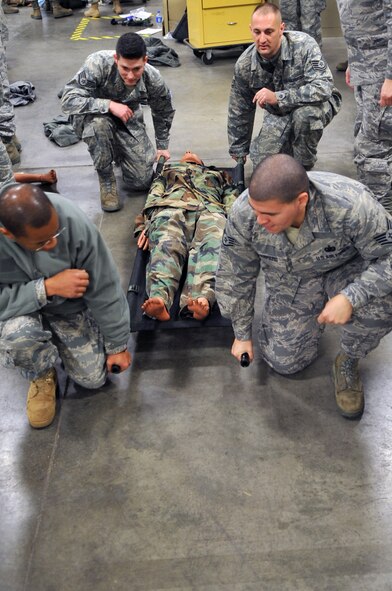 SCOTT AIR FORCE BASE, Ill. -- Team Scott members practice transporting a patient during the Self Aid and Buddy Care training at Scott.  The Airmen were keeping their real-world skills sharp while preparing for upcoming exercises. (Photo by Senior Airman Teresa Jennings)