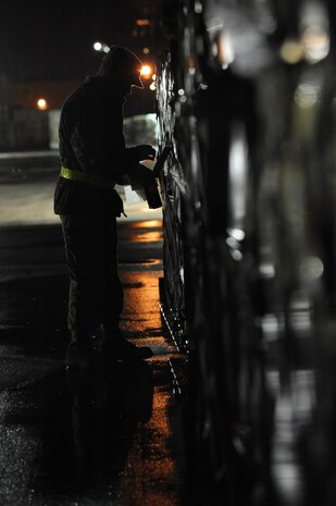 NELLIS AIR FORCE BASE, Nev.-- Senior Airman Kevin Bittner a 99th Logistics Squadron cargo build up augmenttee from the 99th Communications Squadron attaches a Radio Frequency Identification Tag to a pallet in the cargo deployment function yard on Nellis Air Force Base as part of a 99th Air Base Wing operational readiness exercise Jan. 19. The ORE is in preparation for an upcoming operation readiness inspection Jan. 25-29. 
(U.S. Air Force photo by Tech. Sgt. Michael R. Holzworth)
