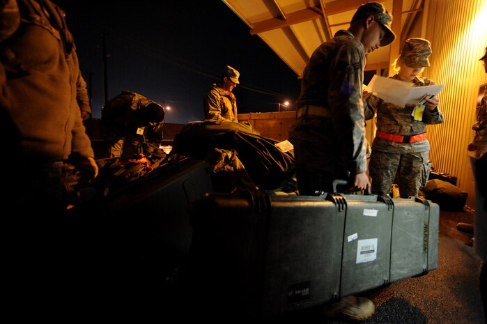 NELLIS AIR FORCE BASE, Nev.-- Airman 1st Class Rachael Crepeau of the 99th Force Support Squadron checks identification cards against a manifest at the entry control point of the  deployment center as part of a 99th Air Base Wing operational readiness exercise Jan. 19. The ORE is in preparation for an upcoming operation readiness inspection Jan. 25-29.  (U.S. Air Force photo by Tech. Sgt. Michael R. Holzworth)