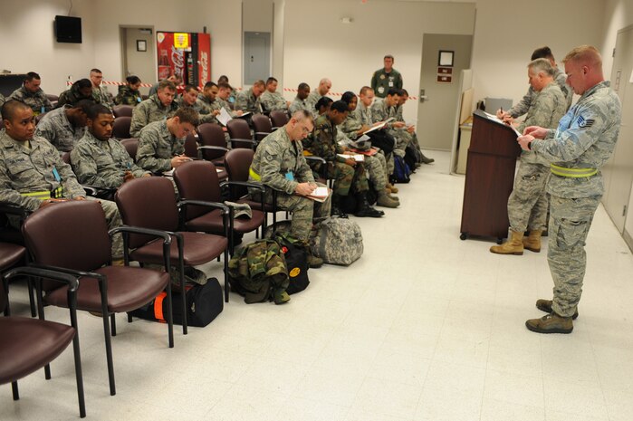 NELLIS AIR FORCE BASE, Nev.-- Staff Sgt. Jacob Taylor of 99th Aerospace Medicine Squadron gives a briefing about pre-deployment health assessment forms,at the deployment center as part of a 99th Air Base Wing operational readiness exercise Jan. 19. The ORE is in preparation for an upcoming operation readiness inspection Jan. 25-29.  (U.S. Air Force photo by Tech. Sgt. Michael R. Holzworth)