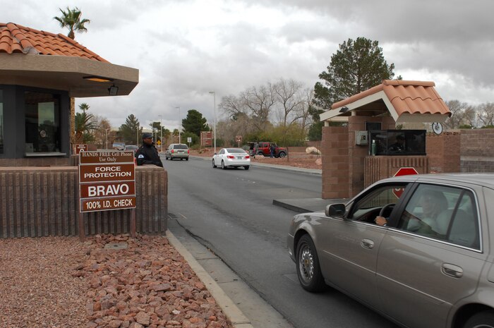 NELLIS AIR FORCE BASE, Nev.-- Mr. Paris Garrett, a Security Officer with TW & Company Inc., checks ID cards at the Nellis front gate while the base is in force protection condition Bravo during Operational Readiness Exercise Cornet White 09-ACC-15. (U.S Air Force photo/ Staff Sgt Taylor Worley)