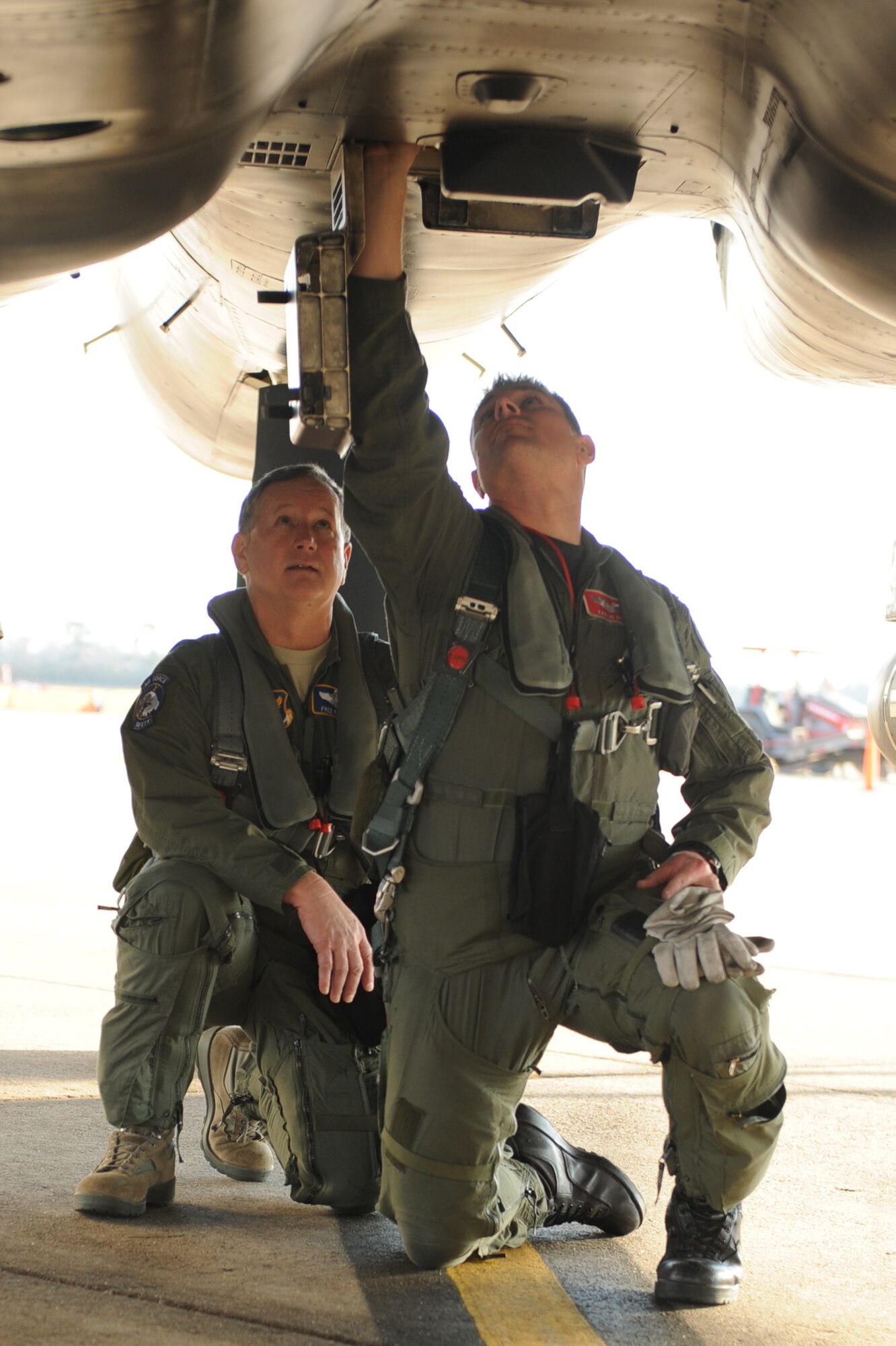 Capt. Aaron Reid, 333rd Fighter Squadron chief of weapons, explains to Maj. Gen. Frederick Roggero, Air Force chief of safety, what to look for during a pre-flight inspection on Seymour Johnson Air Force Base, N.C., Jan. 20, 2010.  During a pre-flight inspection pilots check for leaks, weapons security and abnormalities to ensure the jet is safe to fly. (U.S. Air Force photo/Senior Airman Whitney Lambert)