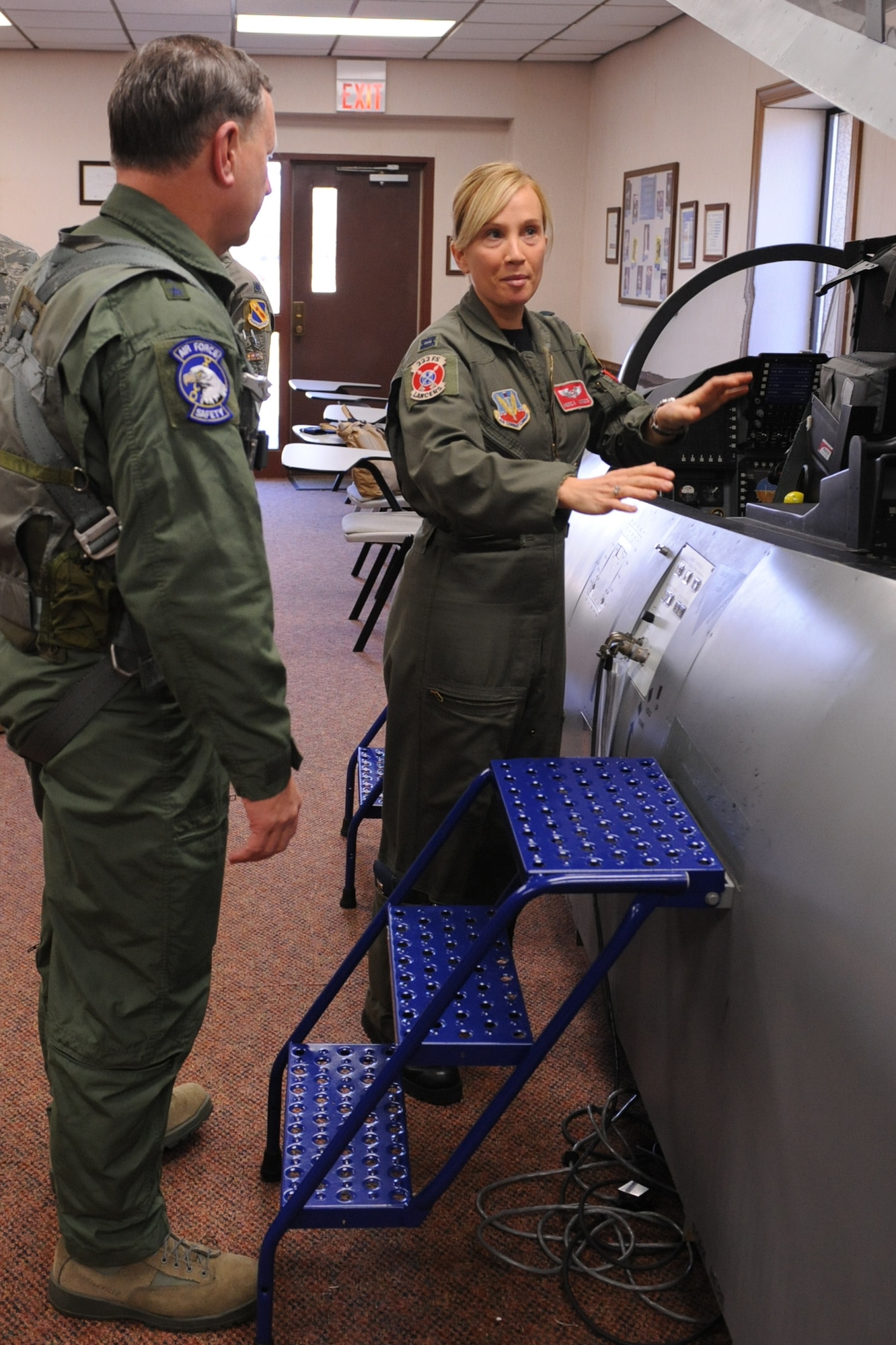 Capt. Andrea Cordes, F-15E weapons system operator instructor, explains proper ingress tactics for an F-15E Strike Eagle to Maj. Gen. Frederick Roggero, Air Force chief of safety, on Seymour Johnson Air Force Base, N.C., Jan. 20, 2010.  Cordes, from Ohio, has been an instructor here for more than two years. (U.S. Air Force photo/Senior Airman Whitney Lambert)