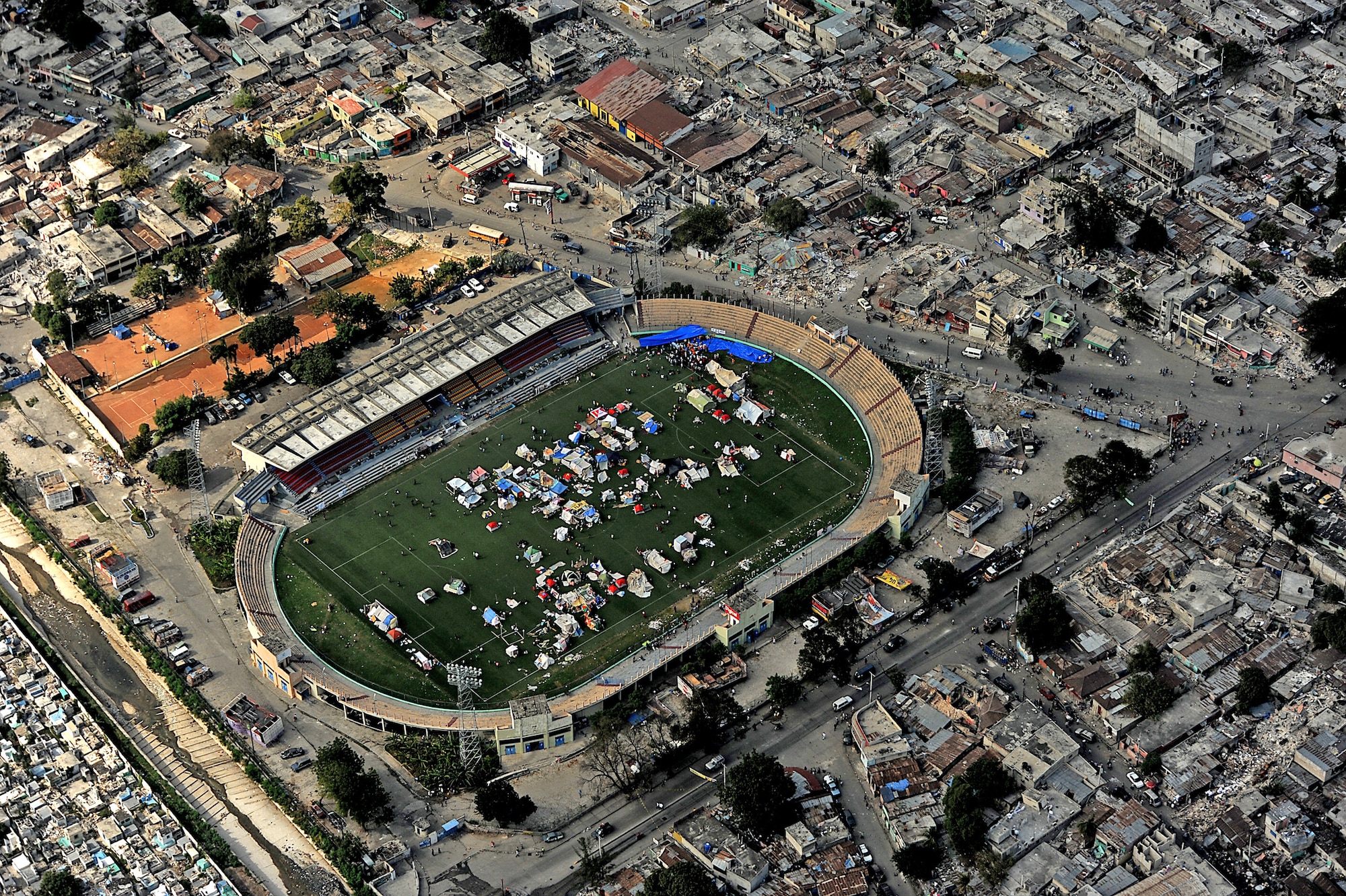 An aerial view shows downtown Port-au-Prince, Haiti, Jan. 17, 2010. Makeshift shelters are being erected in open locations throughout the city in the aftermath of the devastating earthquake that struck the country Jan. 12, 2010. A Jan. 18, 2010, air delivery mission of supplies was directed at trying to find the most expedient method of deploying supplies to victims and relief workers. (DOD photo/Master Sgt. Jeremy Lock)