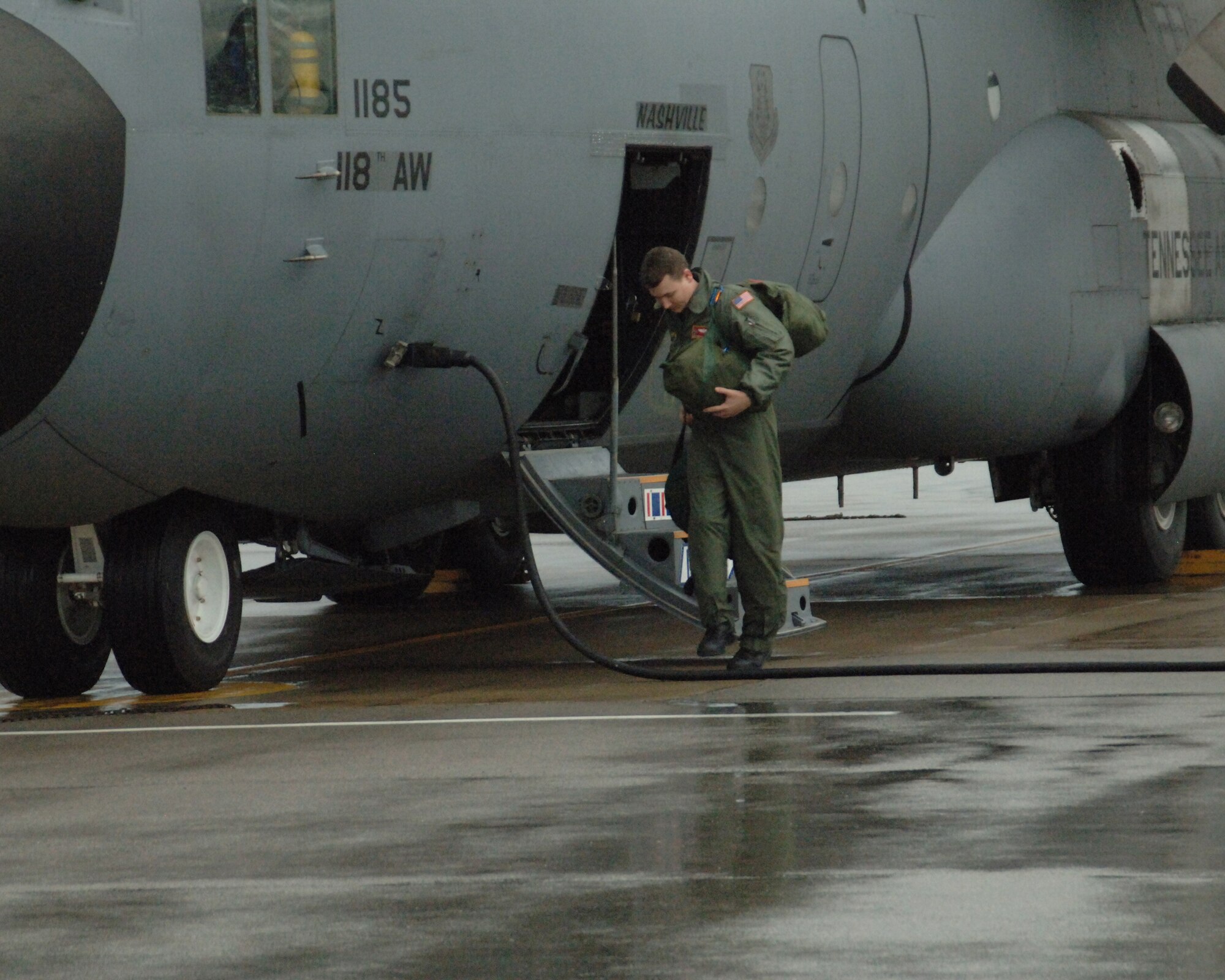 A member of the 118th deboards from the first C-130 to arrive back from Haiti, January 20, 2010. The crew returned more than 60 Americans from Haiti to the United States, dropping them off at Homestead Air Reserve Station, Florida, before returning the Berry Field.