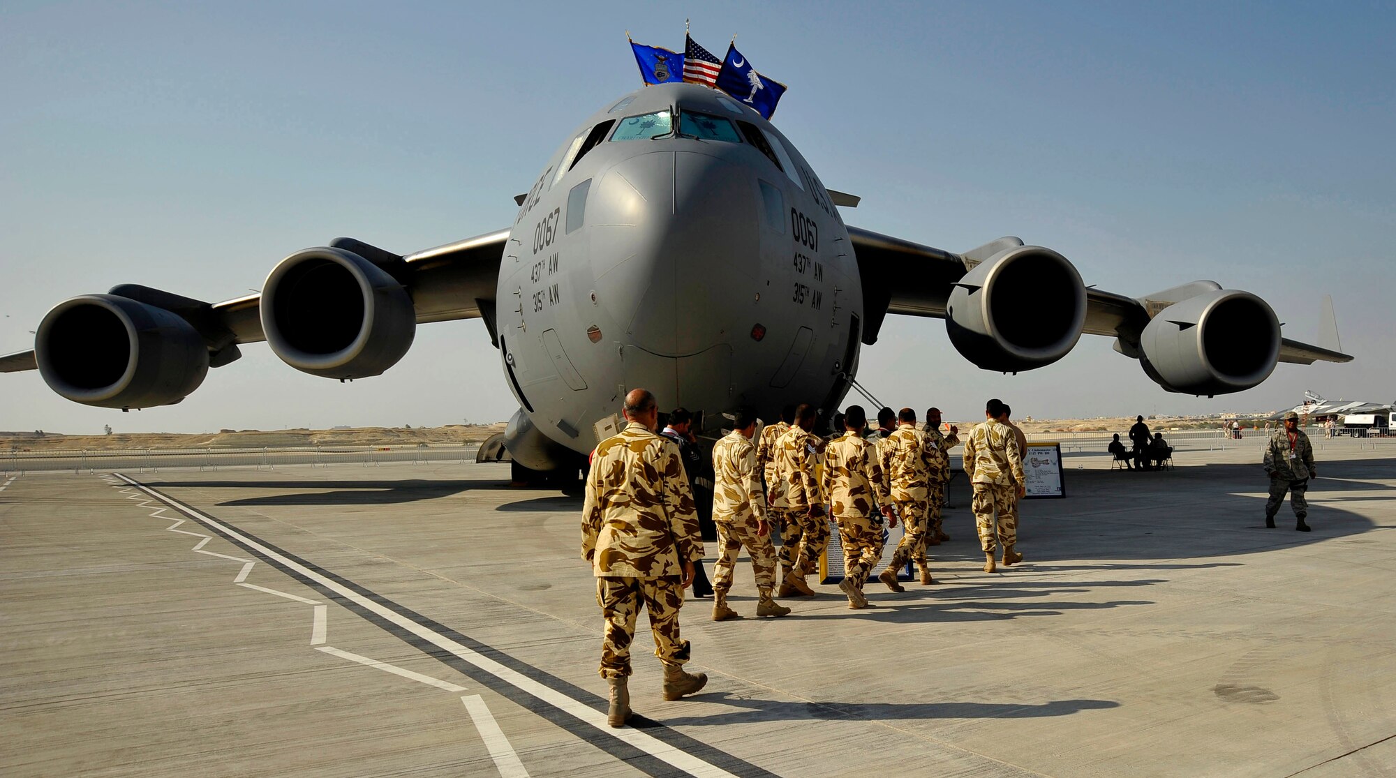U.S. Air Force Airmen escort members of the Bahraini Royal Air Force onto a C-17 Globemaster III for a tour of the aircraft during the Bahrain International Airshow Jan. 21, 2010.   (U.S. Air Force photo/Staff Sgt. Angelita Lawrence/released)