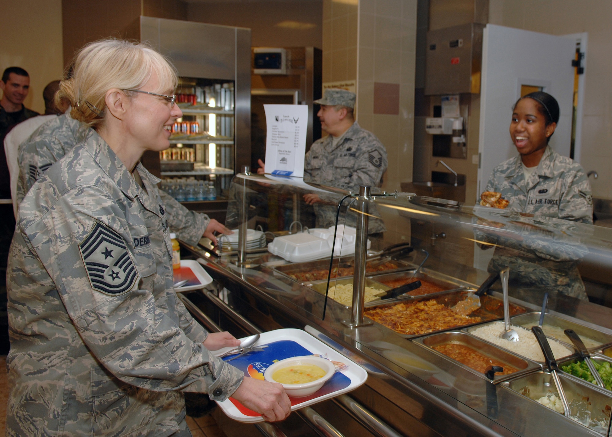 Airman 1st Class Kayla Pace, 31st Force Support Squadron, serves lunch to Chief Master Sgt. Pamela Derrow, U.S. Air Forces in Europe command chief, at La Dolce Vita dining facility during her Jan. 15, 2010 visit to the 31st Fighter Wing. The chief met with base Airmen during a luncheon at La Dolce Vita dining facility. (U.S. Air Force photo/Senior Airman Taylor Marr) 