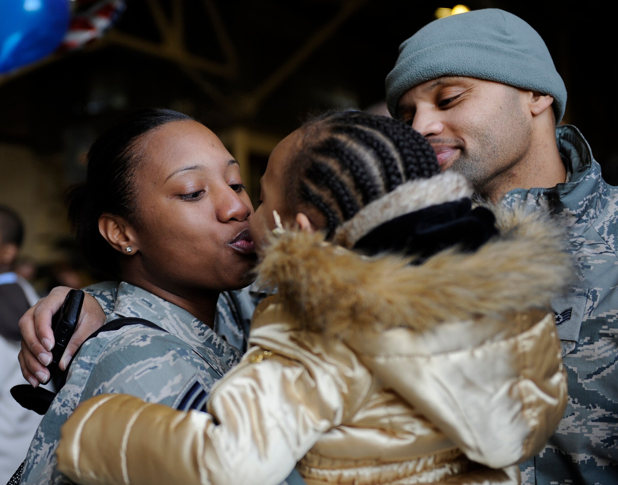 MOUNTAIN HOME AIR FORCE BASE, Idaho -- Staff Sgt. Khyaiisha Guidry, 726th Air Control Squadron air surveillance technician, kisses her daughter, Kemora, after returning home Jan. 19. More than 100 members of the 726th ACS return from their deployments in support of U.S Central Command in Afghanistan and Southwest Asia. (U.S. Air Force photo by Airman 1st Class Renishia Richardson)