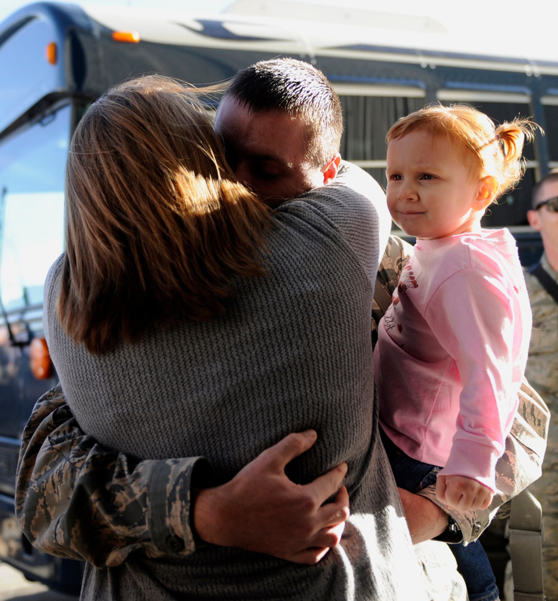 MOUNTAIN HOME AIR FORCE BASE, Idaho -- Staff Sgt. Lloyd Burton, 726th Air Control Squadron, hugs his family after returning home Jan. 19. More than 100 members of the 726th ACS return from their deployments in support of U.S Central Command in Afghanistan and Southwest Asia. (U.S. Air Force photo by Airman 1st Class Renishia Richardson)