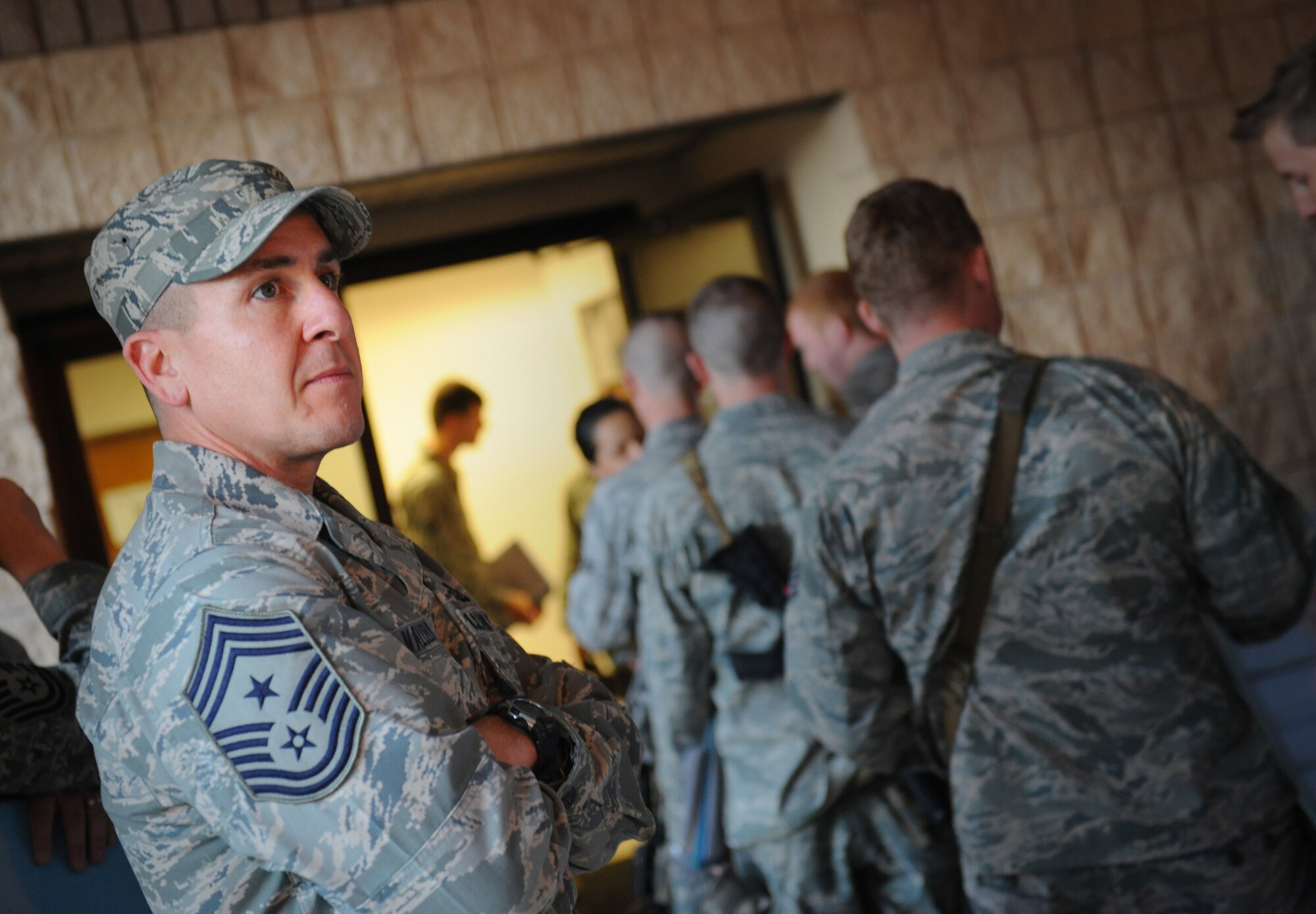 MOODY AIR FORCE BASE, Ga. -- Command Chief Master Sgt. Thomas Vallely, 93rd Air Ground Operations Wing command chief, watches as Airman from the 823rd Security Forces Squadron process through the deployment line here Jan. 20. Members of the 823rd SFS have been tasked for a deployment to Haiti. (U.S. Air Force photo by Senior Airman Gina Chiaverotti-Paige)
