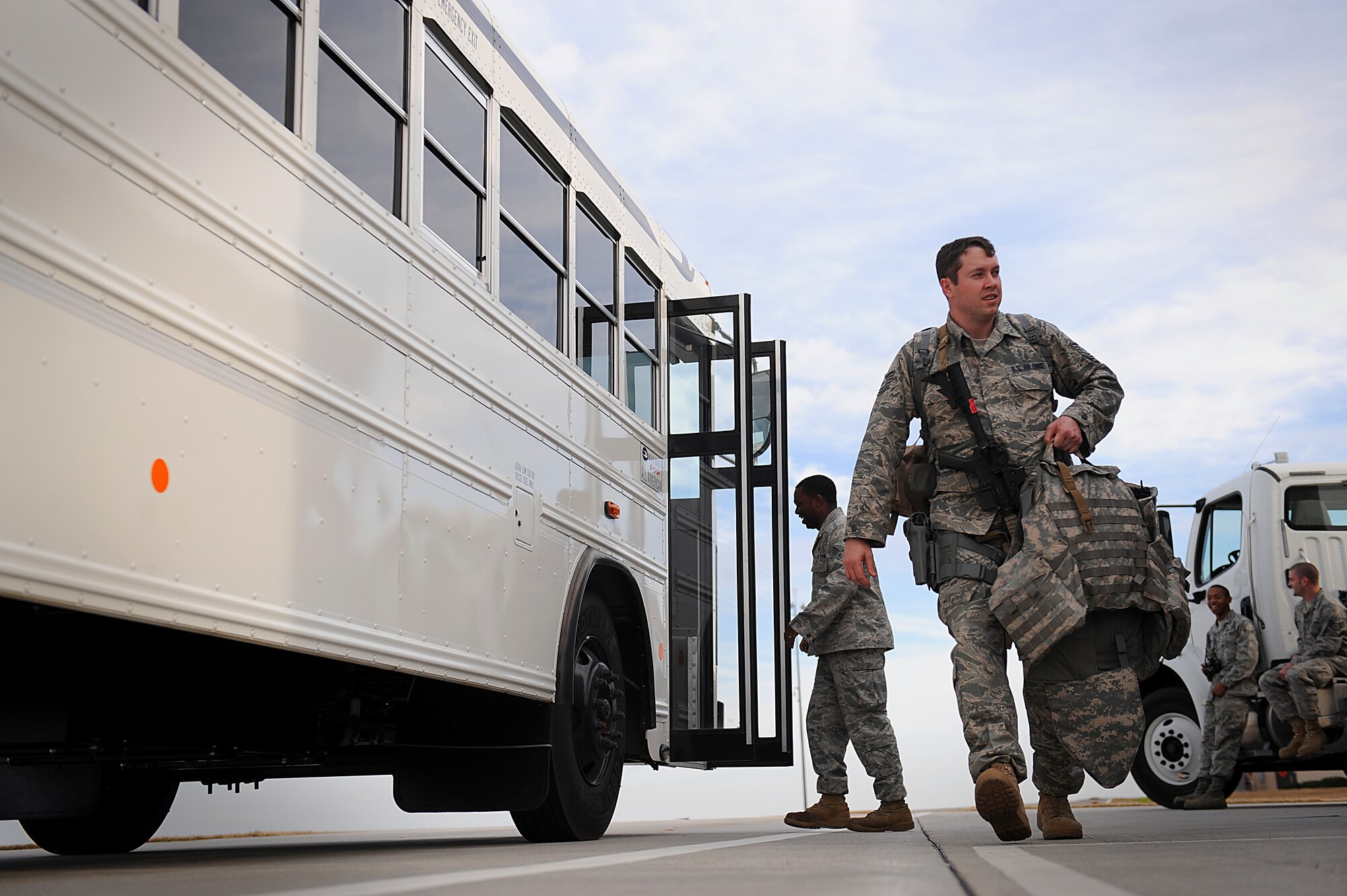 MOODY AIR FORCE BASE, Ga. -- An 823rd Security Forces Squadron Airman carries his gear as he walks toward the rest of his squadron for accountability here Jan. 20. The 823rd SFS has been tasked to deploy in support of Haiti relief efforts. (U.S. Air Force photo by Senior Airman Gina Chiaverotti-Paige)