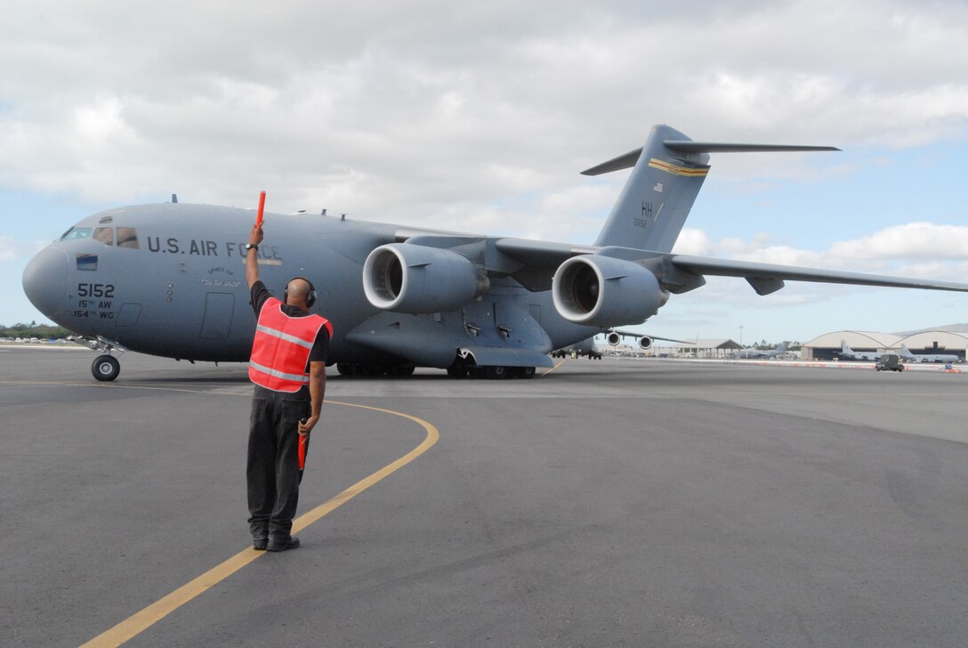 A C-17 Globemaster III departs Jan. 19, 2010, from Hickam Air Force Base, Hawaii, to Charleston AFB, S.C. to take part in humanitarian relief efforts in Haiti. (U.S. Air Force photo/Staff Sgt. Mike Meares)