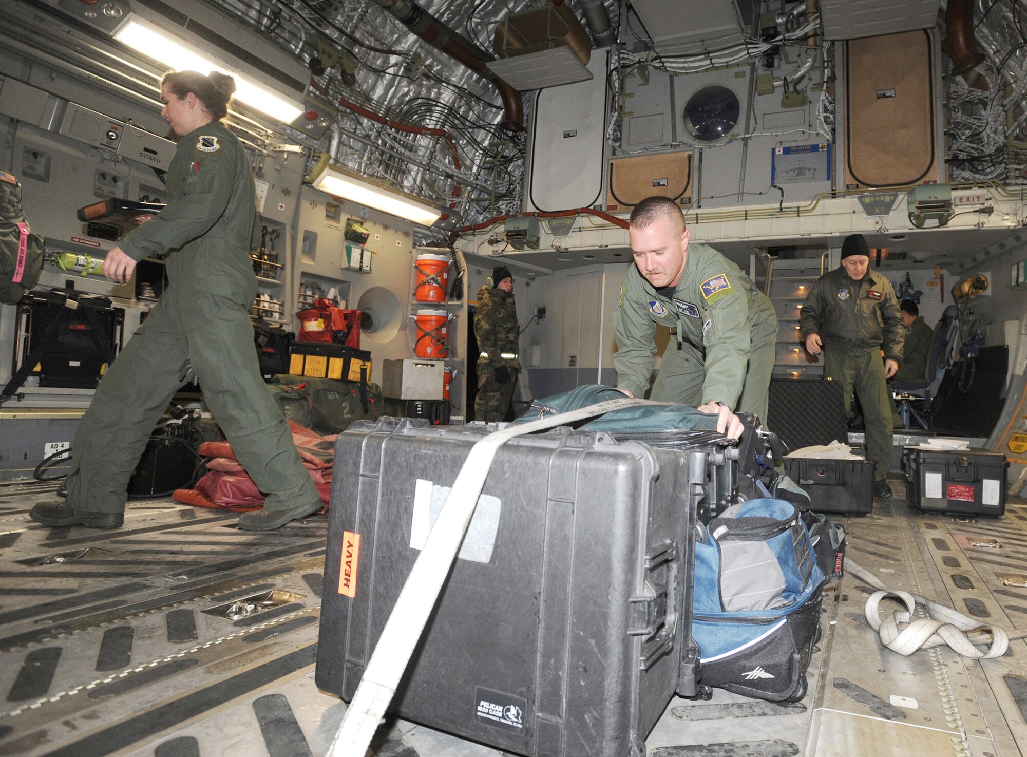 Aircrew members from the 517th Airlift Squadron and 249th Airlift Squadron scramble to deploy to Haiti Jan. 19, 2010, hours after being notified at Elmendorf Air Force Base, Alaska. The crewmembers will assist humanitarian efforts for the earthquake victims in Haiti. (U.S. Air Force photo/Senior Airman Laura Turner)