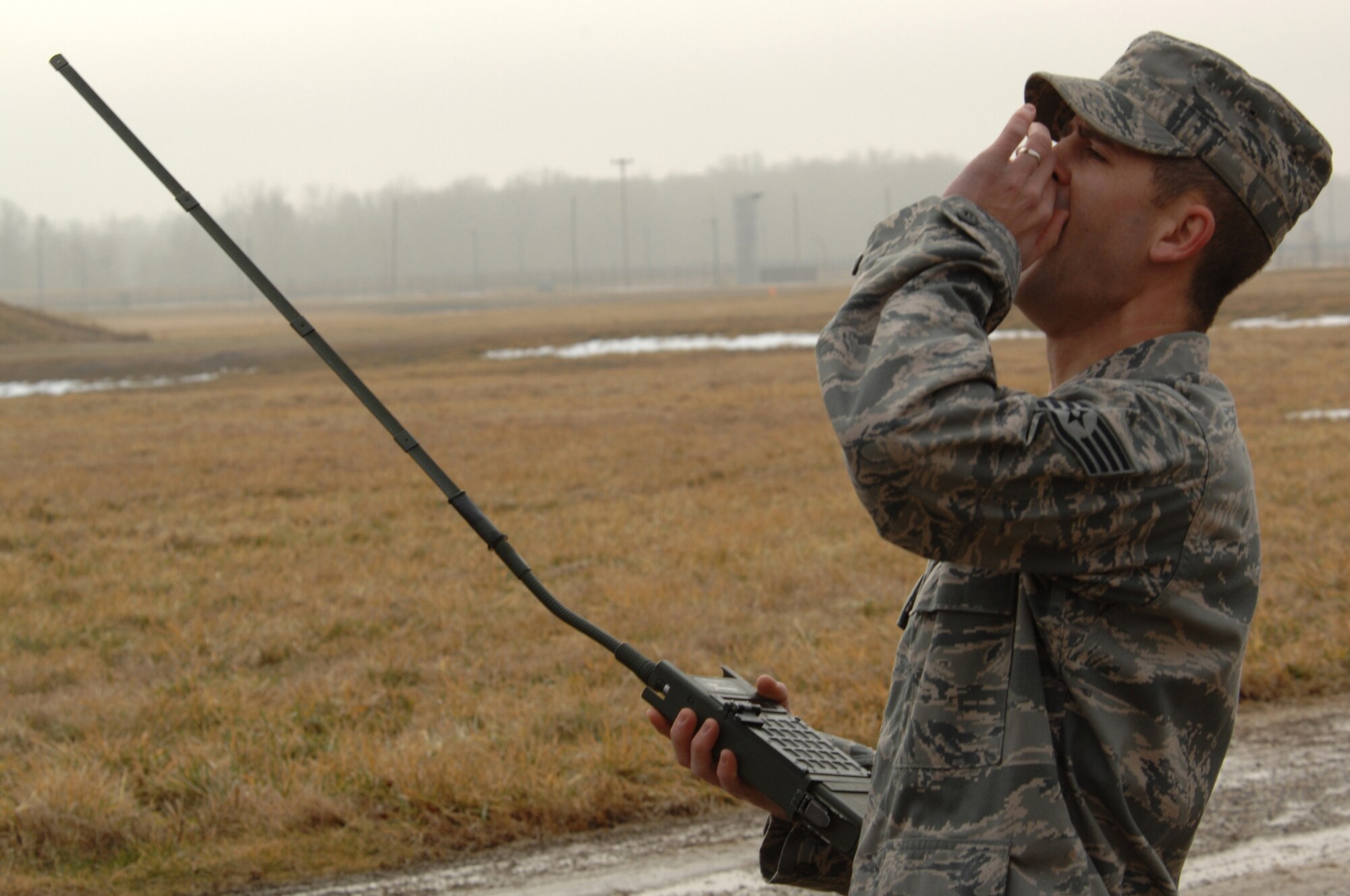 WHITEMAN AIR FORCE BASE, Mo. ? Staff Sgt. Brandon Pfannenstiel, 509th Civil Engineer Squadron Explosive Ordnance Device Technician, yells ?Fire in the hole? before using a remote firing device to set off C-4 during a training session 19 Jan, 2009.  EOD members train often to maintain proficiency because in their line of work there is no room for mistakes.  (U.S. Air Force photo/Senior Airman Jessica Mae Snow) (Released)