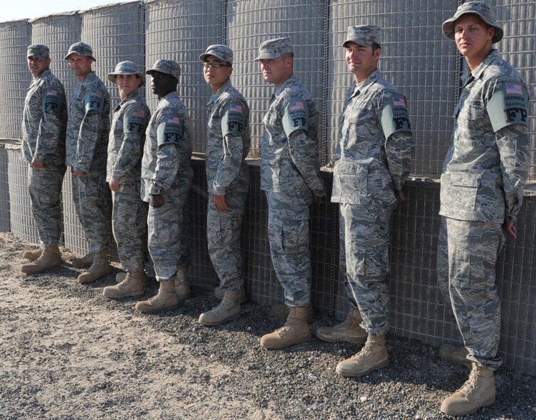 Staff Sgts. Ronald Farris and Richard Romano, Senior Airmen Neil Conn and Tahgie Winkle, Airman 1st Class Sung Choi, Senior Airman Daryl Stout and Airmen 1st Class David Arnold and Mathew Phillips, all B-1B Lancer maintenance Airmen deployed as force protection escorts to the 380th Air Expeditionary Wing at a non-disclosed base in Southwest Asia, are shown Jan. 19, 2010.  All eight of the Airmen are from Dyess Air Force Base, Texas. They assisted in recovering a B-1 that had to make an emergency landing to their base Jan. 12, 2009. They helped with the maintenance and inspection of the aircraft in addition to completing their force protection duties.  (U.S. Air Force Photo/Tech. Sgt. Scott T. Sturkol/Released)