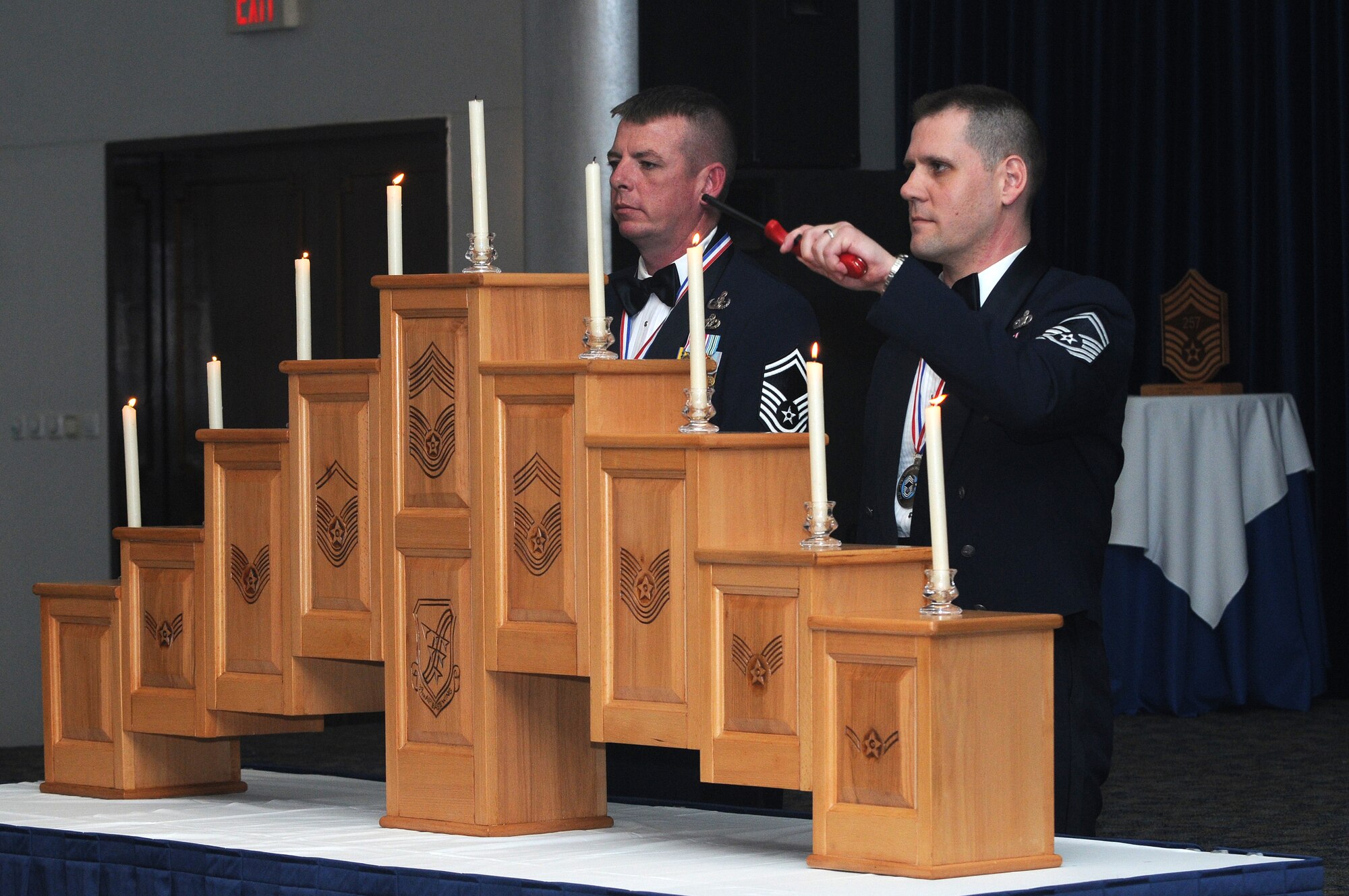 Chief Master Sgt. selects Jeffery Hurley and Sheldon Parrish light candles to represent each rank they have attained throughout their career Friday, Jan. 15, 2010 during the chief’s recognition ceremony at Incirlik’s Consolidated Club.  The chief’s recognition ceremony is an annual event to recognize and congratulate Airmen on attaining their new rank of Chief Master Sergeant.  (U.S. Air Force photo/Senior Airman Ashley Wood)   