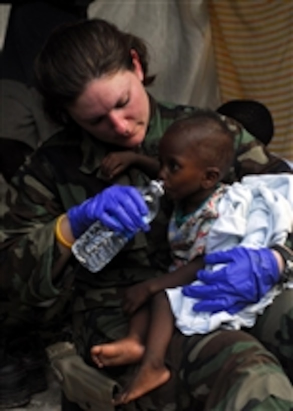 U.S. Navy Chief Petty Officer Rioni, a member of a Maritime Civil Affairs team, gives water to a severely dehydrated Haitian child in Bonel, Haiti, on Jan. 19, 2010.  The civil affairs team is part of the Bataan Amphibious Relief Mission that is supporting Operation Unified Response.  This joint operation is providing military support to civil authorities to help stabilize and improve the situation in Haiti following a 7.0-magnitude earthquake.  