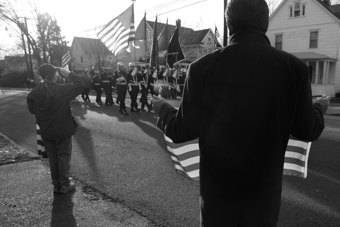 WESTWOOD, N.J. - People line the street to honor a local Marine killed in Afghanistan, Jan. 21. The body of Sgt. Christopher R. Hrbek, 25, a Westwood, N.J., native, was escorted from Dover Air Force Base, Del., past streets lined with people waving American Flags to Beckers Funeral Home. Hrbek, a field artillery cannoneer with 3rd Battalion, 10th Marine Regiment, Regimental Combat Team 7, II Marine Expeditionary Force, died Jan. 14 while conducting combat operations in Helmand Province, Afghanistan. The Bronze Star Medal with combat distinguishing device is scheduled to be presented to his family at his funeral, Jan. 23.  The medal was approved for saving the life of his battalion sergeant major after an improvised explosive device severed both his legs during a firefight, Dec. 23, 2009. (Official Marine Corps photo by Sgt. Randall A. Clinton)