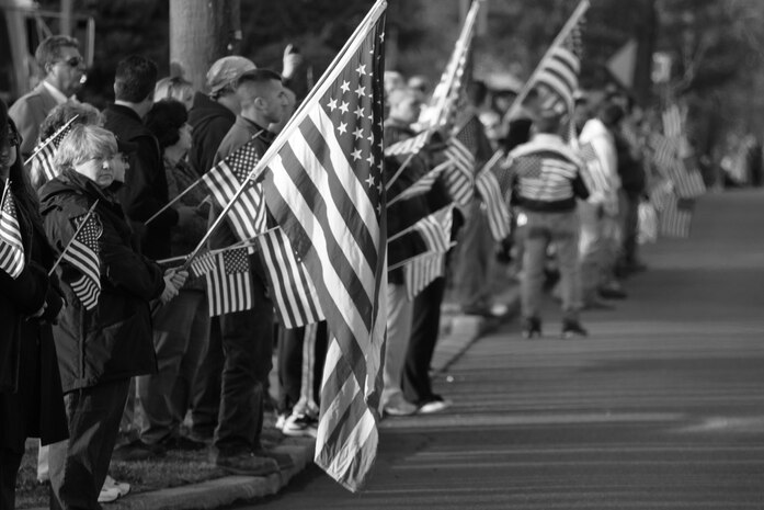 WESTWOOD, N.J. - People line the street to honor a local Marine killed in Afghanistan, Jan. 21. The body of Sgt. Christopher R. Hrbek, 25, a Westwood, N.J., native, was escorted from Dover Air Force Base, Del., past streets lined with people waving American Flags to Beckers Funeral Home. Hrbek, a field artillery cannoneer with 3rd Battalion, 10th Marine Regiment, Regimental Combat Team 7, II Marine Expeditionary Force, died Jan. 14 while conducting combat operations in Helmand Province, Afghanistan. The Bronze Star Medal with combat distinguishing device is scheduled to be presented to his family at his funeral, Jan. 23.  The medal was approved for saving the life of his battalion sergeant major after an improvised explosive device severed both his legs during a firefight, Dec. 23, 2009. (Official Marine Corps photo by Sgt. Randall A. Clinton)