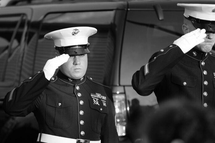 WESTWOOD, N.J. - Marines who served with Sgt. Christopher R. Hrbek, 25, a Westwood, N.J., native, salute as his casket is taken inside Beckers Funeral Home, Jan. 21. He was escorted from Dover Air Force Base, Del., past streets lined with people waving American Flags here. Hrbek, a field artillery cannoneer with 3rd Battalion, 10th Marine Regiment, Regimental Combat Team 7, II Marine Expeditionary Force, died Jan. 14 while conducting combat operations in Helmand Province, Afghanistan. The Bronze Star Medal with combat distinguishing device is scheduled to be presented to his family at his funeral, Jan. 23.  The medal was approved for saving the life of his battalion sergeant major after an improvised explosive device severed both his legs during a firefight, Dec. 23, 2009. (Official Marine Corps photo by Sgt. Randall A. Clinton)