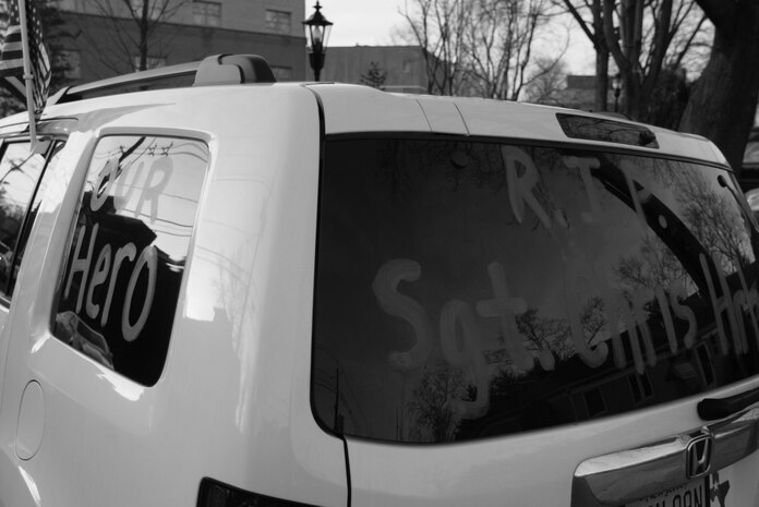 WESTWOOD, N.J. - A car parked near the Beckers Funeral Home displays a tribute to Sgt. Christopher R. Hrbek, 25, a Westwood, N.J., native, Jan. 21. He was escorted from Dover Air Force Base, Del., past streets lined with people waving American Flags here. Hrbek, a field artillery cannoneer with 3rd Battalion, 10th Marine Regiment, Regimental Combat Team 7, II Marine Expeditionary Force, died Jan. 14 while conducting combat operations in Helmand Province, Afghanistan. The Bronze Star Medal with combat distinguishing device is scheduled to be presented to his family at his funeral, Jan. 23.  The medal was approved for saving the life of his battalion sergeant major after an improvised explosive device severed both his legs during a firefight, Dec. 23, 2009. (Official Marine Corps photo by Sgt. Randall A. Clinton)