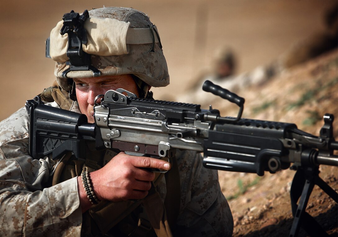 Lance Cpl. Seth T. Lima, from Safety Harbor, Fla., takes position with his squad Jan. 21 during a battalion-sized practice attack on a military range here. Lima is serving with Company F, Battalion Landing Team 2/4, the ground combat element of the 11th Marine Expeditionary Unit.