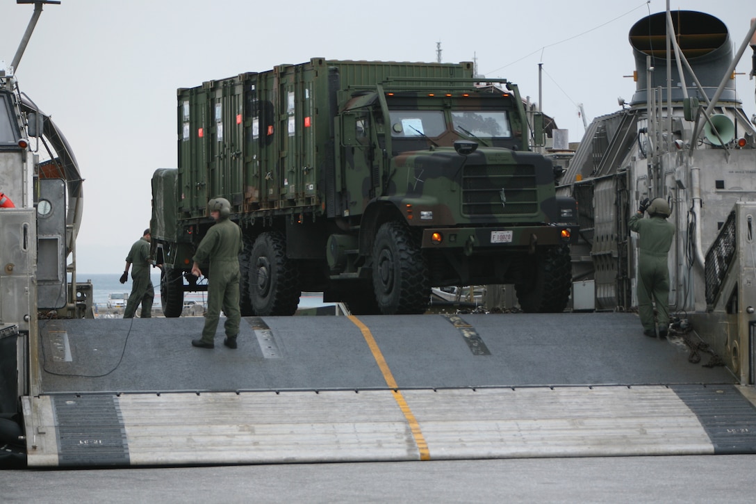 Sailors from Assault Craft Unit One (ACU-1), secure vehicles to a landing craft air cushion (LCAC), Jan. 22. More than 170 vehicles and 450 tons of equipment from the 31st Marine Expeditionary Unit (MEU) were embarked aboard the forward-deployed Essex Amphibious Ready Group (ARG) in support of the Spring Patrol. The MEU’s first scheduled exercise is Cobra Gold 2010 (CG’ 10).  CG’ 10 is the latest in a continuing series of exercises designed to promote regional peace and security.