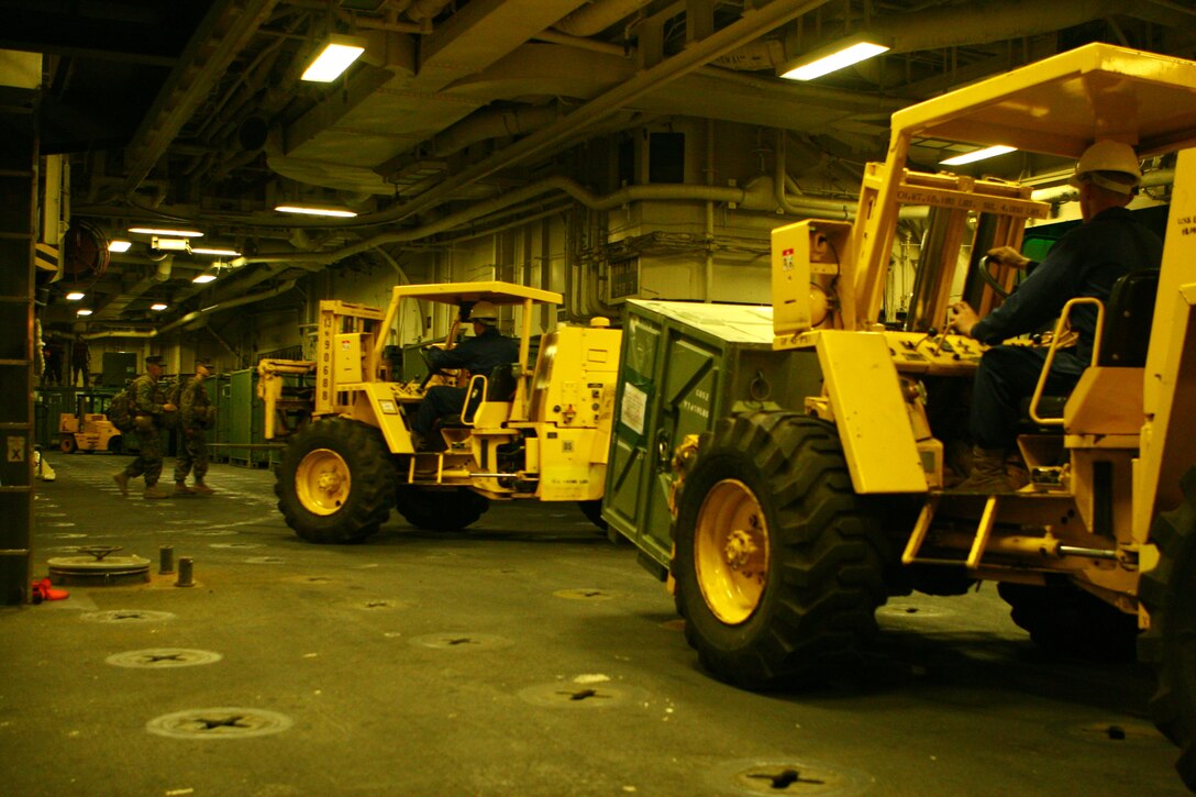 Marines and sailors from the forward-deployed Essex Amphibious Ready Group (ARG) and the 31st Marine Expeditionary Unit (MEU) load equipment onto the amphibious assault ship USS Essex (LHD 2), Jan. 22. More than 170 vehicles and 450 tons of equipment from the 31st MEU were embarked aboard the forward-deployed Essex Amphibious Ready Group (ARG) in support of the Spring Patrol. The MEU’s first scheduled exercise is Cobra Gold 2010 (CG’ 10).  CG’ 10 is a regularly scheduled joint and coalition multinational exercise hosted annually by the Kingdom of Thailand.