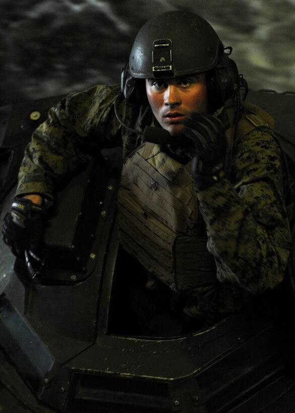 A Marine assigned to the 31st Marine Expeditionary Unit waits for the last of 15 amphibious assault vehicles to enter the welldeck of the forward-deployed amphibious transport dock USS Denver (LPD 9). Denver is part of the forward-deployed Essex Amphibious Ready Group and is conducting a spring patrol of the Asia Pacific region with embarked Marines from the 31st Marine Expeditionary Unit.