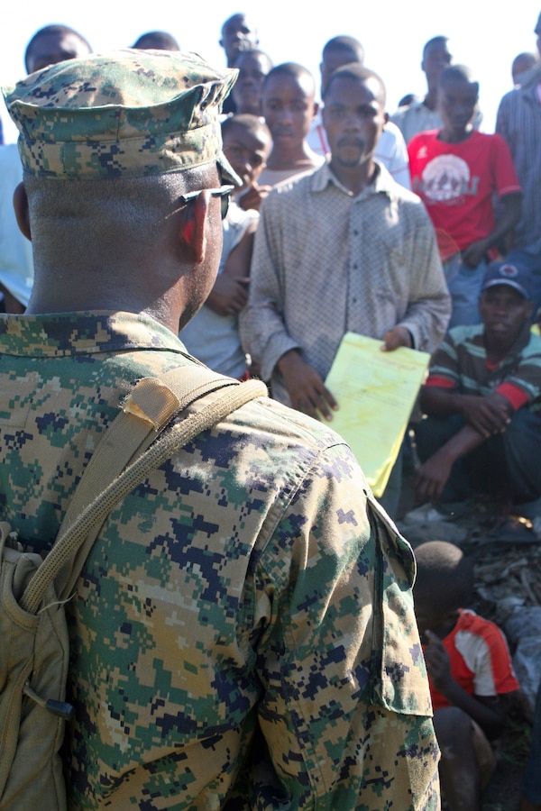 An interpreter with Battalion Landing Team, 3rd Battalion, 2nd Marine Regiment, 22nd Marine Expeditionary Unit, speaks with locals of Leogane, Haiti, Jan. 22, 2010.  The 22nd MEU has distributed supplies in the area to aid earthquake victims since Jan. 19, 2010. (Official Marine Corps photograph by LCpl David Castillo)::r::::n::
