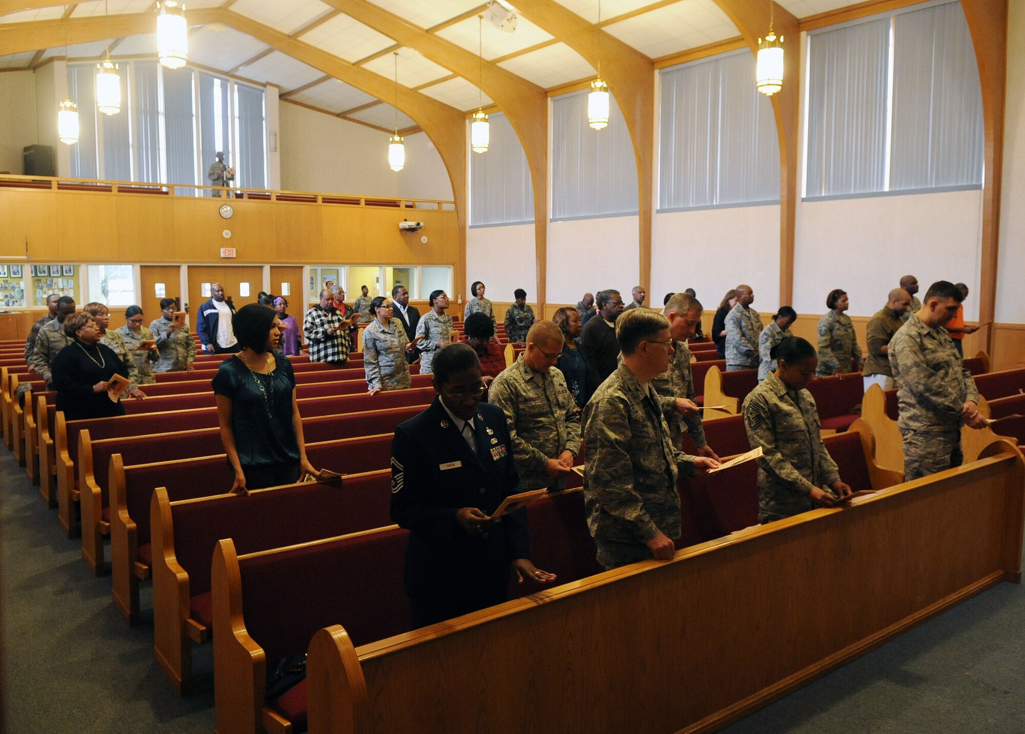 Barksdale AFB, La- Members of the audience joins in on the singing of a musical selection with the Barksdale Chapel Choir, during the Dr. Martin Luther King Jr. commemorative service here Jan. 15. (U.S. Air Force photo by Senior Airman La'Shanette V. Garrett)(RELEASED)