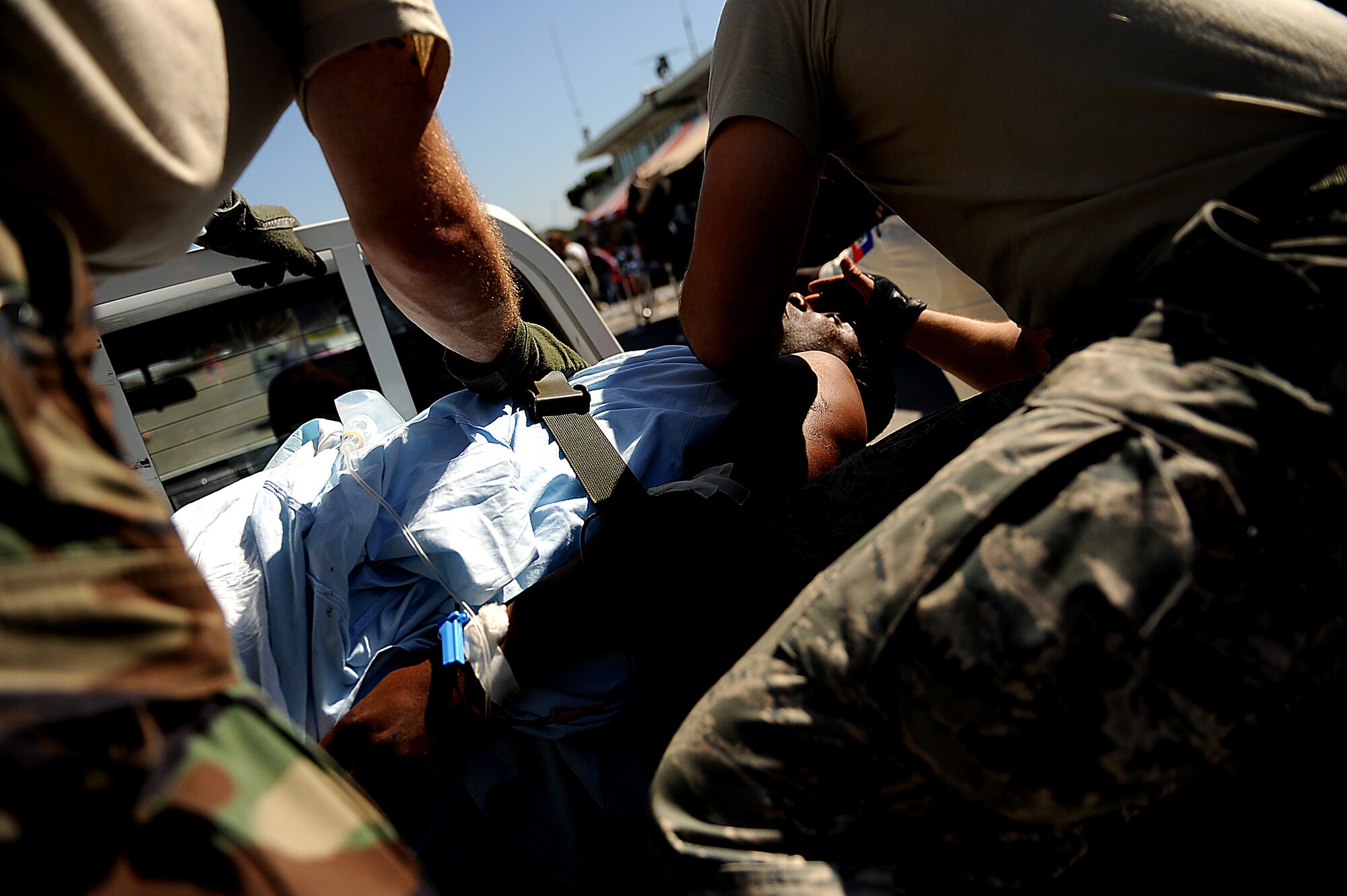 Medics from the 1st Special Operations Support Squadron perform urgent medical care on a Haitian man at the Toussaint Louverture International Airport in Port-au-Prince, Haiti, Jan. 18. The man was injured in the Jan. 12 7.0-magnitude earthquake. (U.S. Air Force photo by Master Sgt. Jeremy Lock/Released)