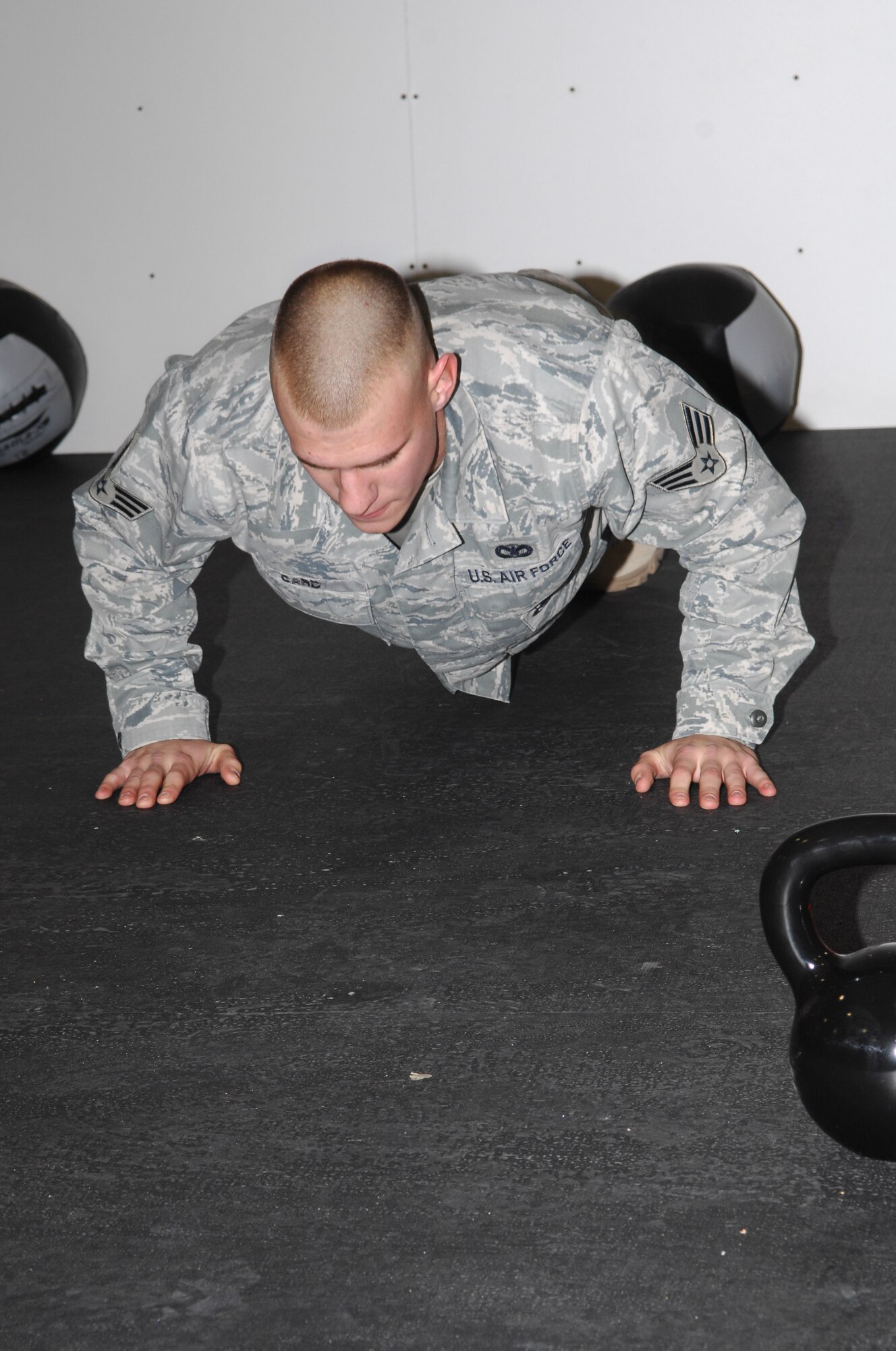 Senior Airman Jeremy Card from the 56th Security Forces Squadron does push-ups after the grand opening of the new Combat Physical Training center at Luke Air Force Base, AZ. (Air Force photo/Staff Sgt. Steve Nabor)
