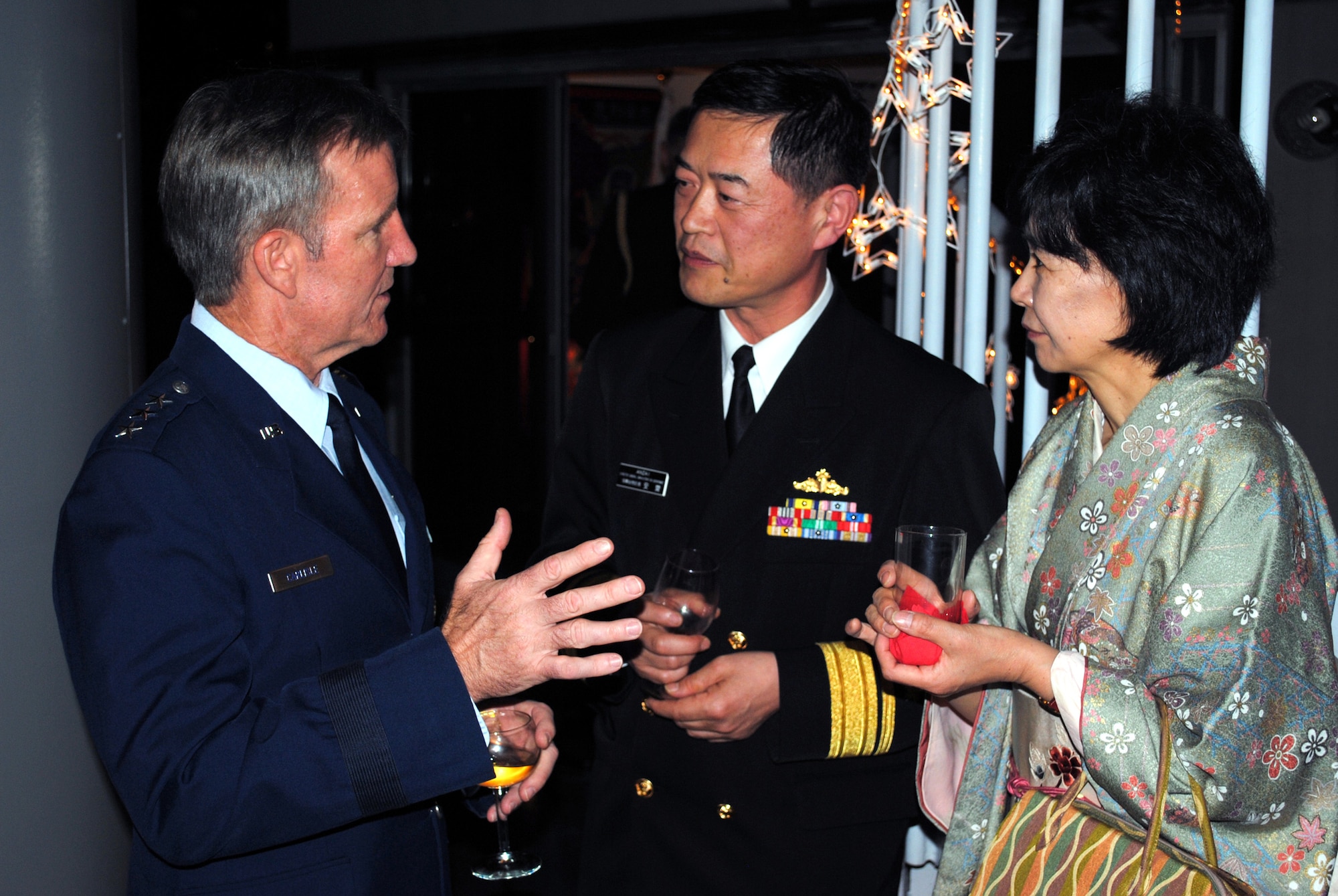 Lt. Gen. Herbert J. "Hawk" Carlisle (left), 13th Air Force commander, talks with Japan Rear Adm. Tsutomu Anzai, Maritime Self-Defense Force director general of administration, and his wife, Kazuko, at a U.S. Embassy reception Jan. 19, 2010, to celebrate the 50th anniversary of the signing of the Treaty of Mutual Cooperation and Security. (U.S. Air Force photo/Capt. Will Powell)