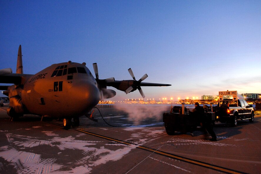 In the orange light of the setting sun 15 December 2009 a 133rd Airlift Wing, Minnesota Air National Guard C-130 H model cargo aircraft prepares for a cold weather training flight. The Lockheed C-130 Hercules is a four-engine turboprop military transport aircraft built by Lockheed. Capable of takeoffs and landings from unprepared runways. The C-130H model has updated Allison T56-A-15 turboprops, a redesigned outer wing, updated avionics and other minor improvements.
U.S. Air Force photo by Tech. Sgt. Erik Gudmundson. 