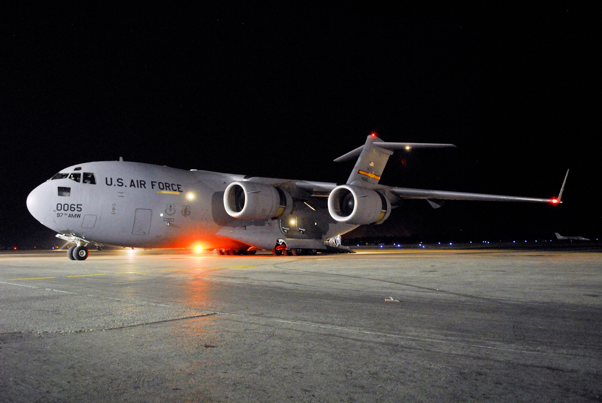 A C-17 Globemaster III waits to load passengers at Toussaint L'Ouverture International Airport in Port-au-Prince, Haiti, Jan. 19, 2010. The C-17, based out of Altus Air Force Base, Okla., was flown by three pilots with nearly 20,000 flight hours combined experience. Capt. Harold Kramer of the 58th Airlift Squadron was aircraft commander.  (U.S. Air Force photo/1st Lt. Matt Schroff)