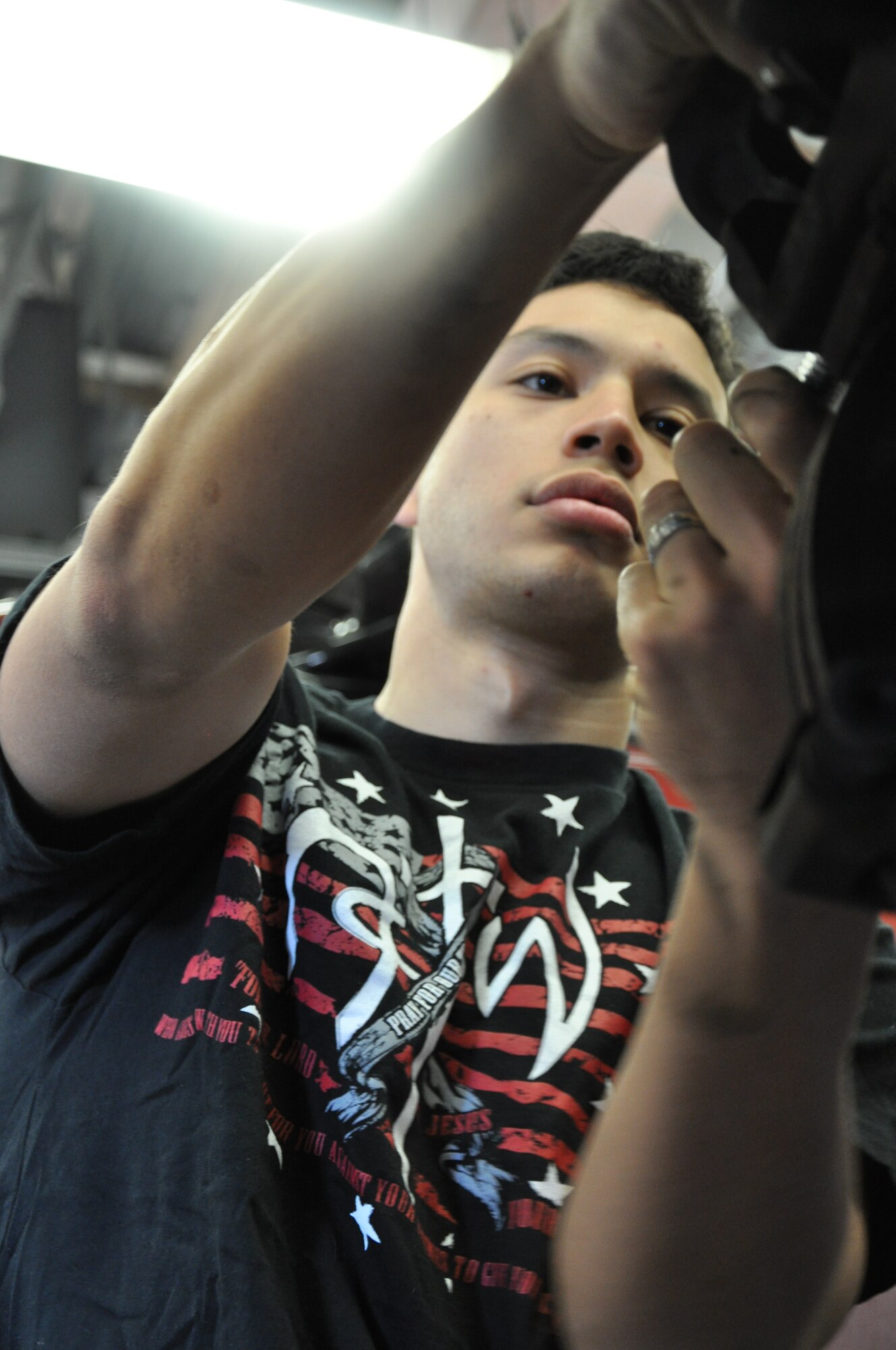 LAUGHLIN AIR FORCE BASE, Texas –Second Lt. Mike Mayor, 47th Operations Support Squadron, works on the front brakes of a car at the Auto Crafts Center here, Jan. 16. The Center held the two-hour class to teach Airmen how to properly install new brakes on their own vehicles. (U.S. Air Force photo by Tech. Sgt. Charlie Miller)