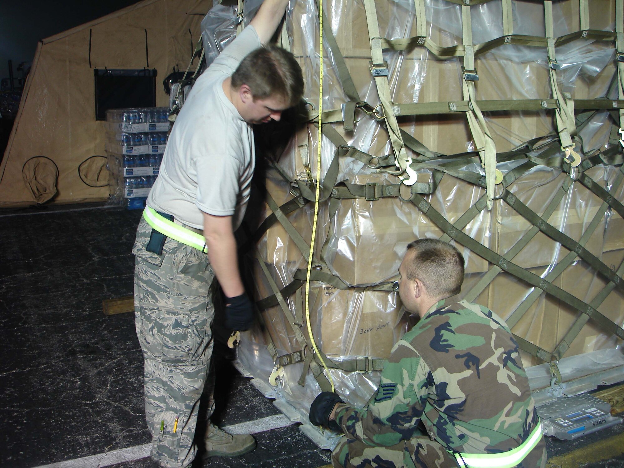 Tech. Sgt Scott Johnston (left) and Staff Sgt. Christopher Platz, both
aerial porters from the 27th Aerial Port Squadron with the 934th Airlift
Wing, prepare a pallet to be transported to Haiti. Currently there are 37
members of the 27th APS at Homestead Air Force Base, Fla., helping palletize
supplies for the relief effort for the Caribbean country. (Photo courtesy of
U.S. Air Force)
                               