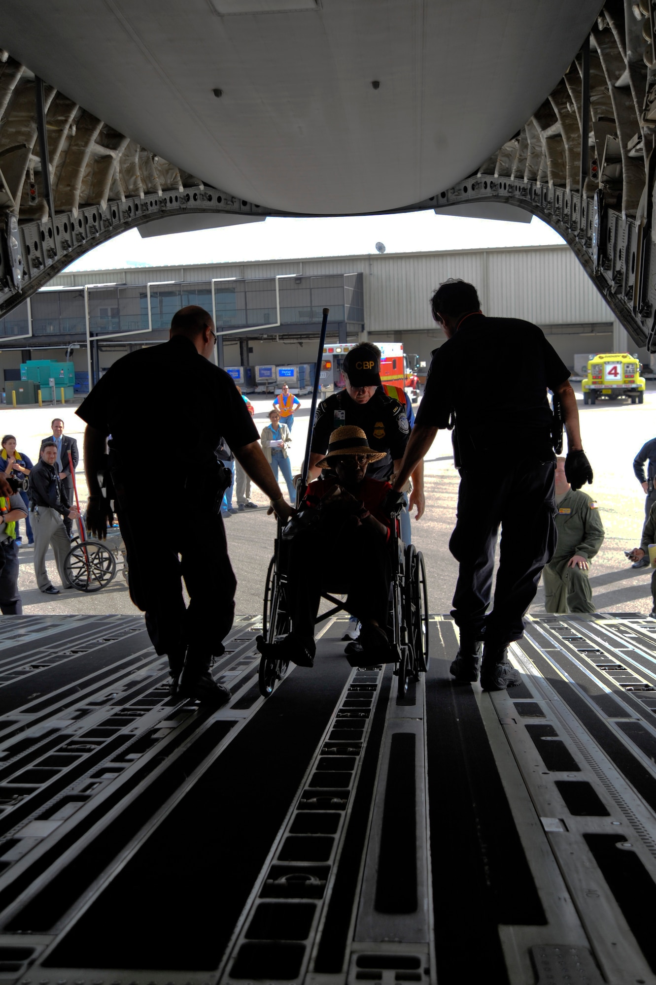 An evacuee from Haiti is wheeled off the ramp of  a C-17 Globemaster III by U.S. Customs and Border Protection agents at Orlando Sanford International Airport Jan. 21. The C-17 carried more than 100 evacuees from Haiti after a 7.0 magnitude earthquake hit the country Jan. 12, the evacuees consisted of American and Haitian citizens.

(U.S. Air Force photo by Staff Sgt. Joseph L. Swafford Jr./Released)
