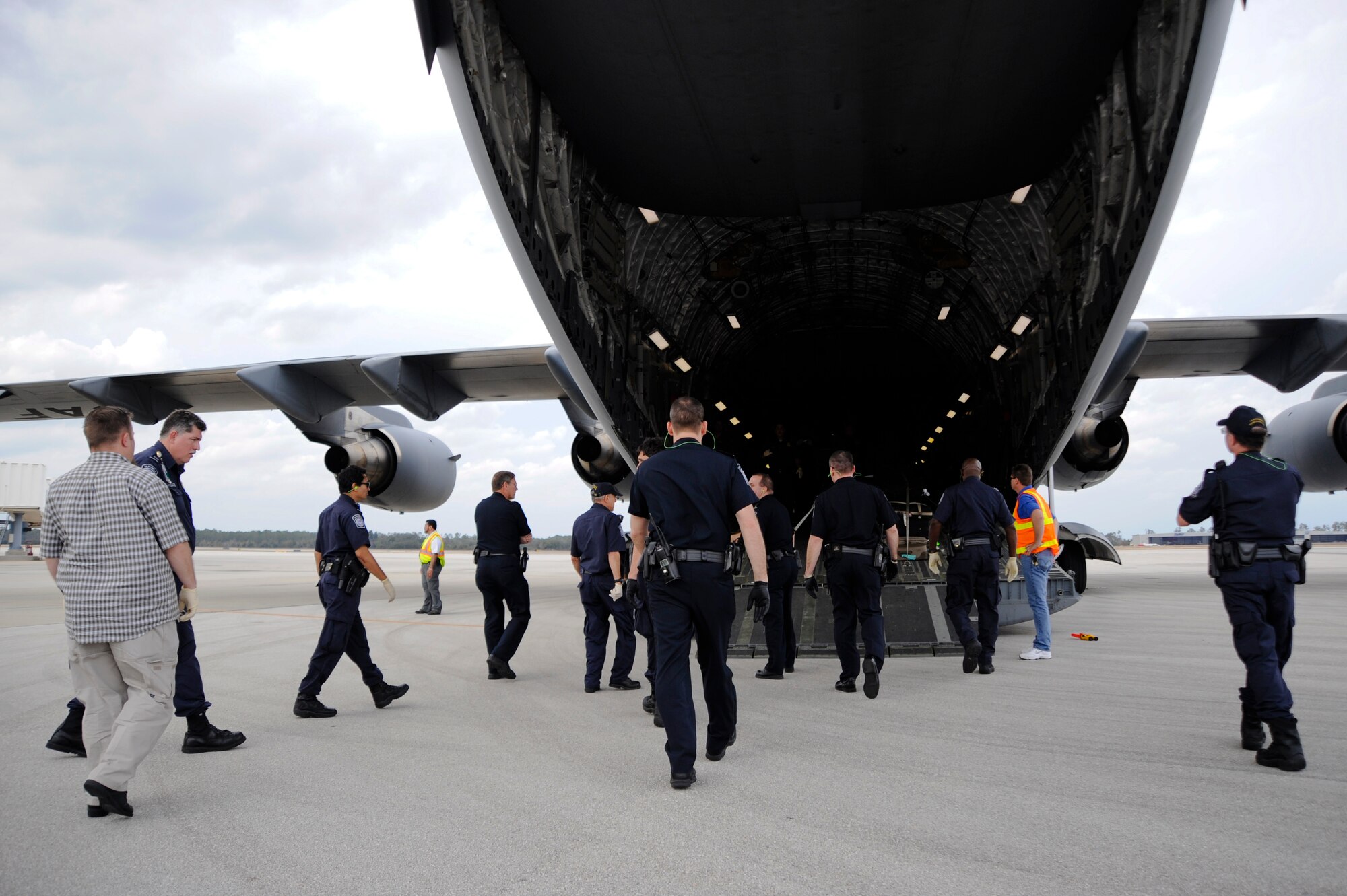 U.S. Customs and Border Protection agents approach a C-17 Globemaster III to help a group of evacuees from Haiti unload at the Orlando Sanford International Airport Jan. 21. The C-17 carried more than 100 evacuees from Haiti  after the country was hit by an earthqauke Jan. 12. The evacuees consisted of American and Haitian citizens.
(U.S. Air Force photo by Staff Sgt. Joseph L. Swafford Jr./Released)
