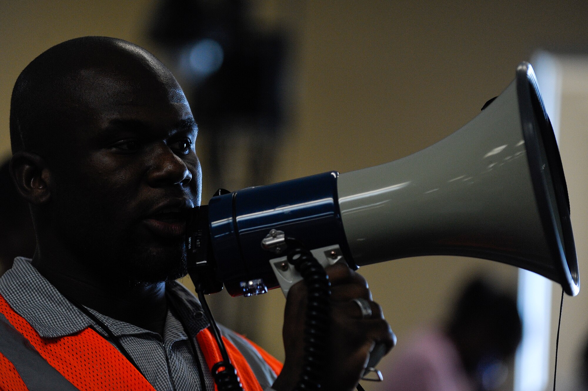 Laventure Paul, Haitian translator, directs evacuees from the Haiti earthquake after they arrived by a C-17 Globemaster III at Orlando Sanford International Airport Jan. 21. Most of the evacuees are U.S. citizens who were visiting Haiti when the earthquake struck Jan. 12. Some of the passengers returning are Haitian orphans.
(U.S. Air Force photo by Staff Sgt. Joseph L. Swafford Jr./Released)
